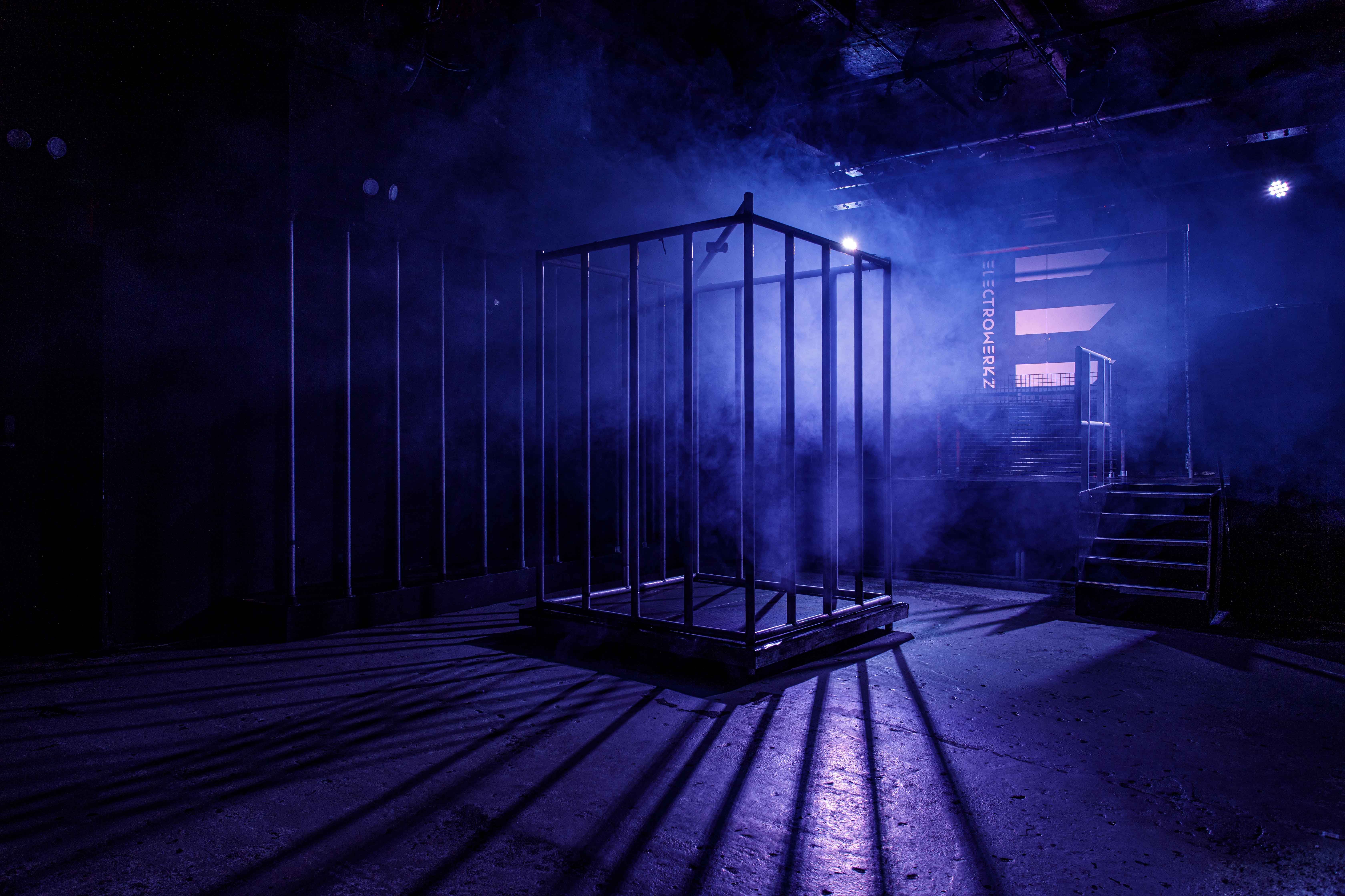 Whole Venue at Electrowerkz: illuminated cage and fog create dramatic events setting.