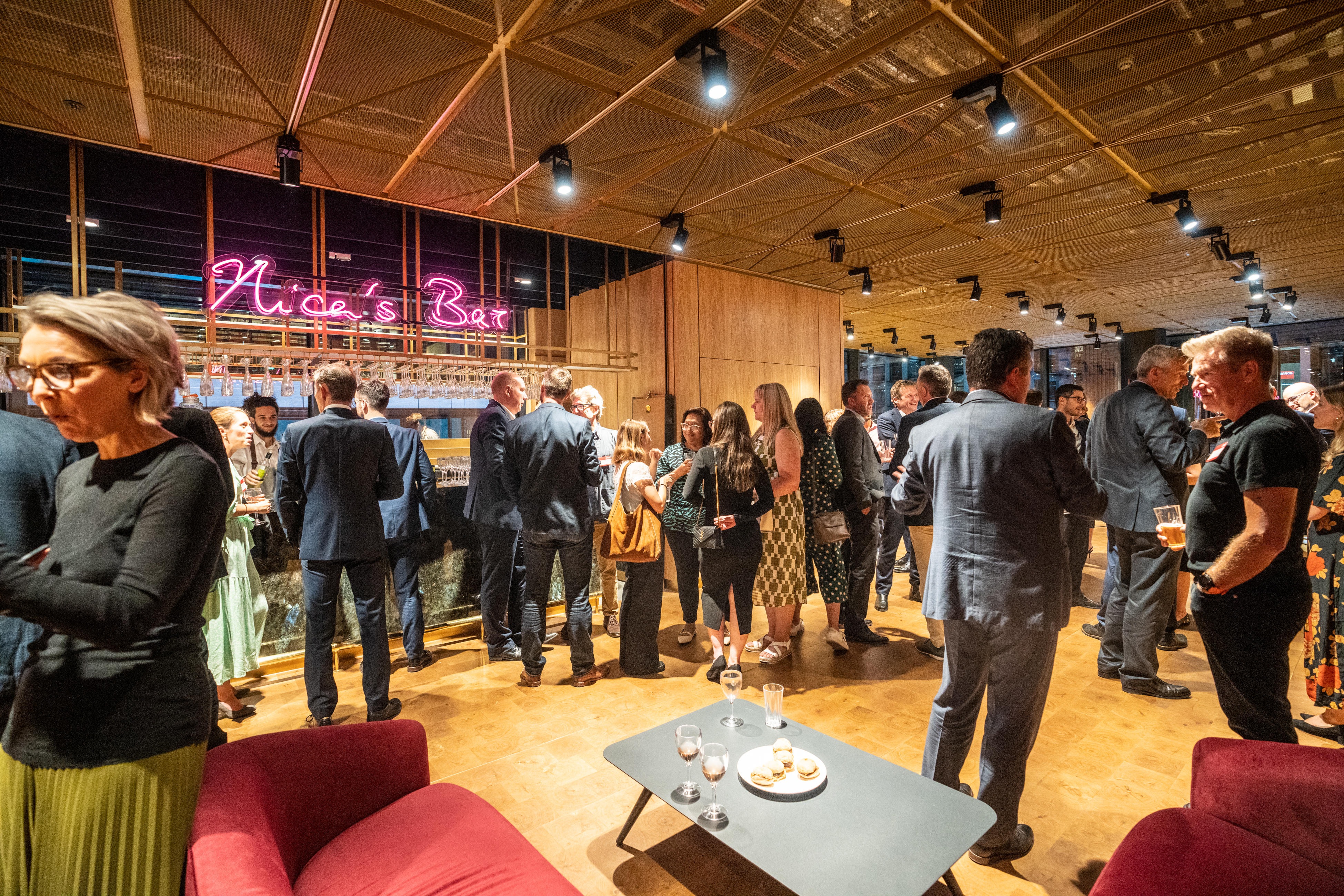 Vibrant networking event at Nica's Bar, modern decor, ideal for mixology and corporate receptions.