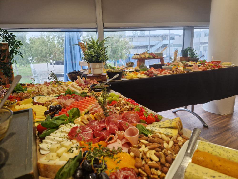 Gourmet buffet at London Cable Car event with cheeses and cured meats.