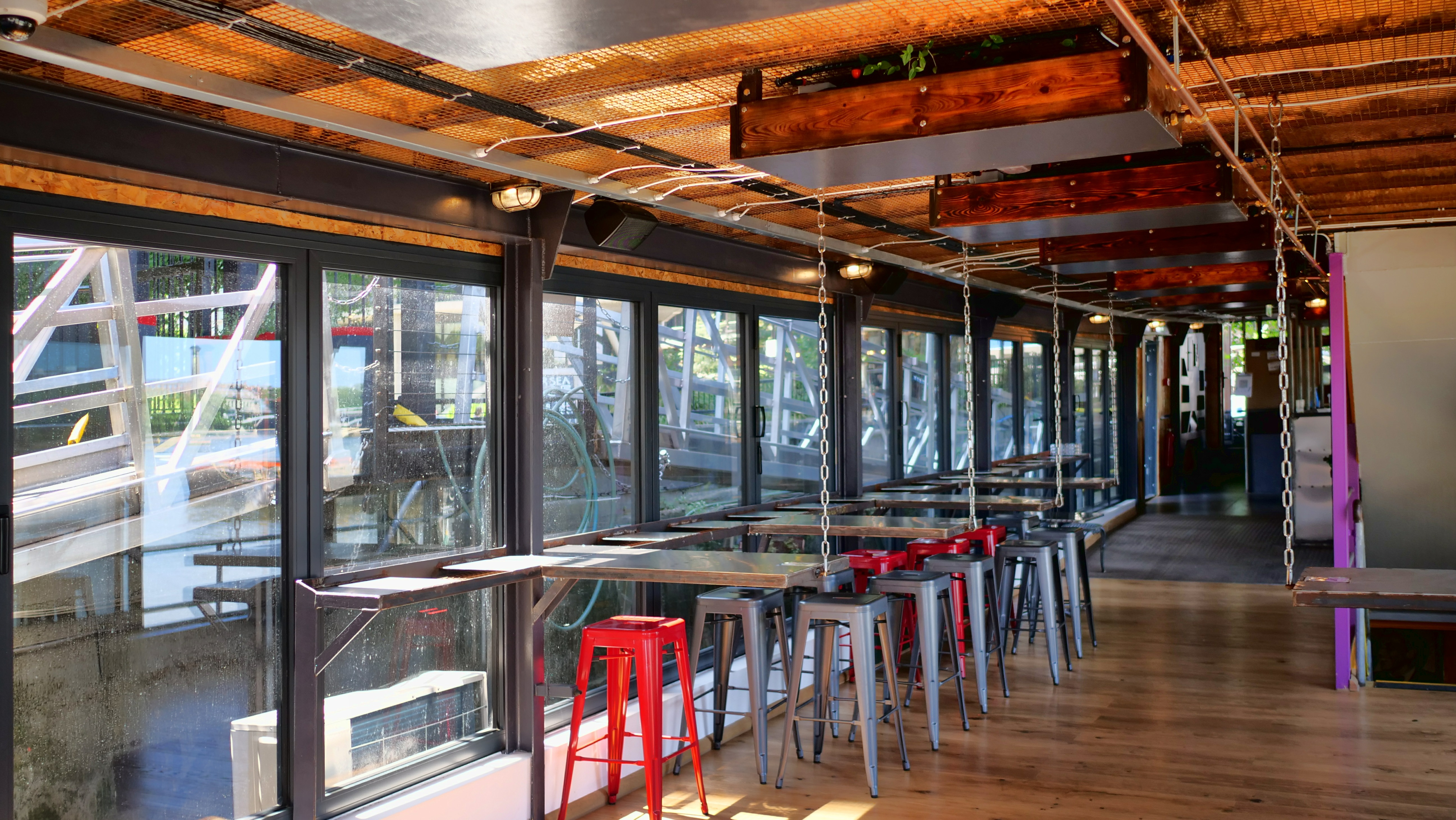 Bright indoor event space with large windows in Battersea Barge, perfect for meetings and gatherings.