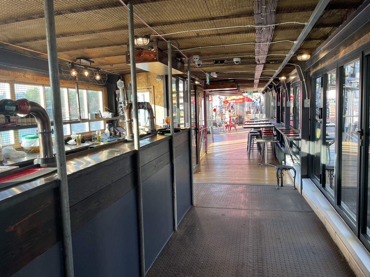 Stylish indoor event space with bar and natural light at Battersea Barge for receptions.