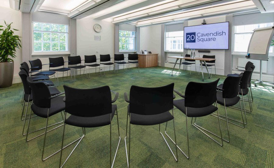Versatile meeting space with black chairs and natural light for collaborative sessions.