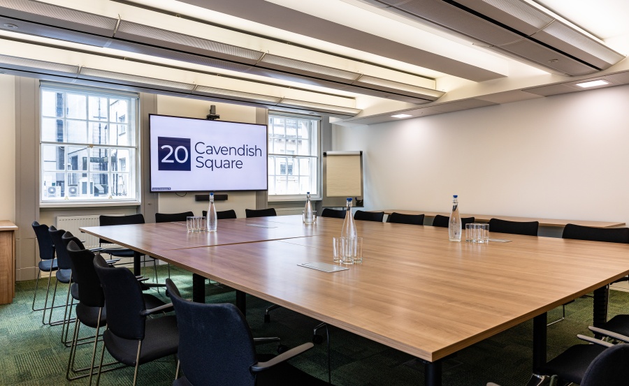 Modern conference room at Edith Cavell, featuring a large table for corporate meetings. 
