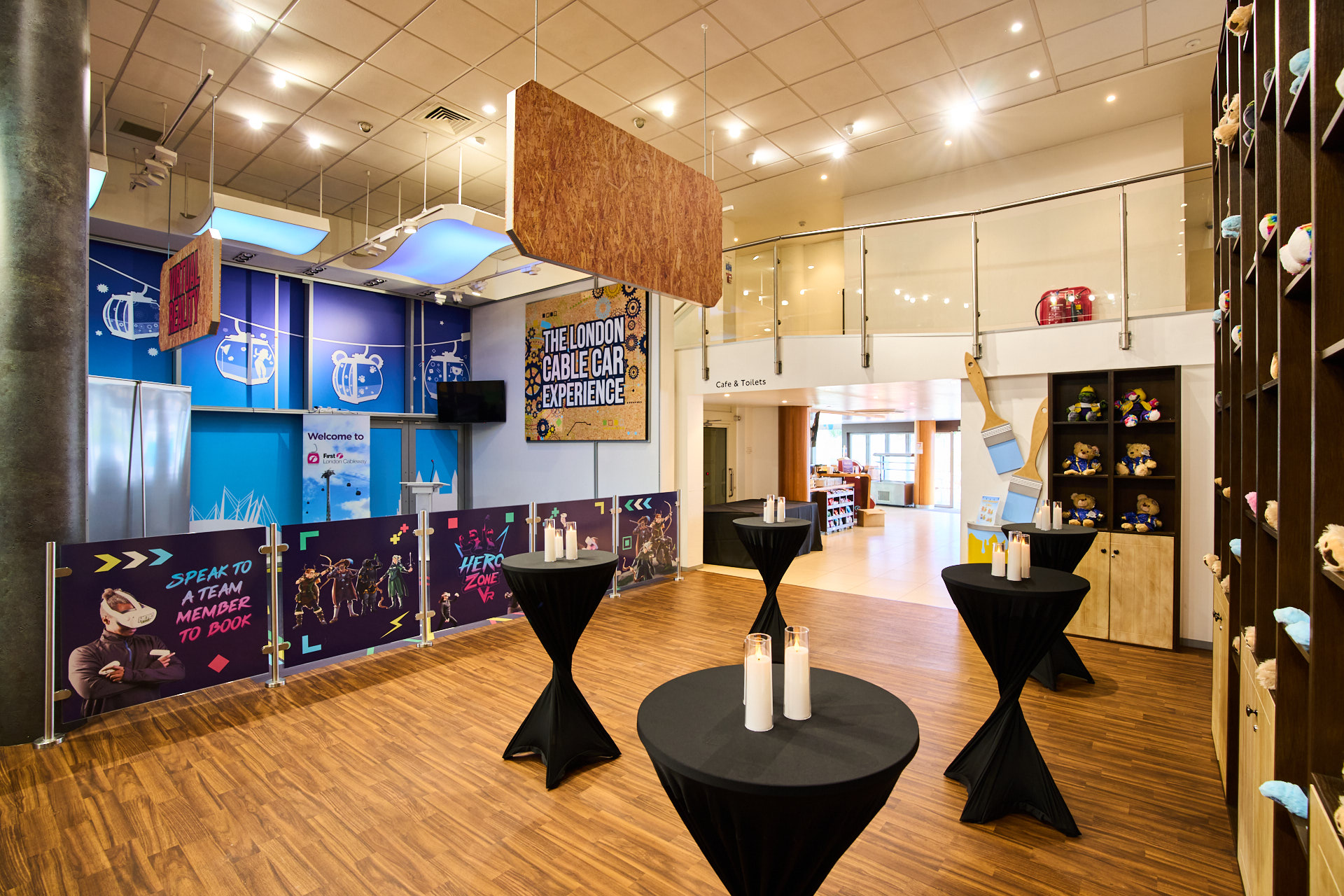 "Elegant Christmas party setup with black cocktail tables at IFS Cloud Cable Car, London."