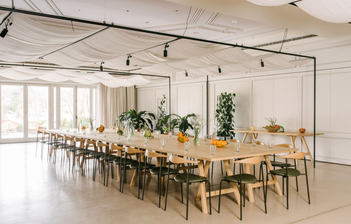 Heckfield Place Assembly Room with elegant table for meetings and brainstorming events.