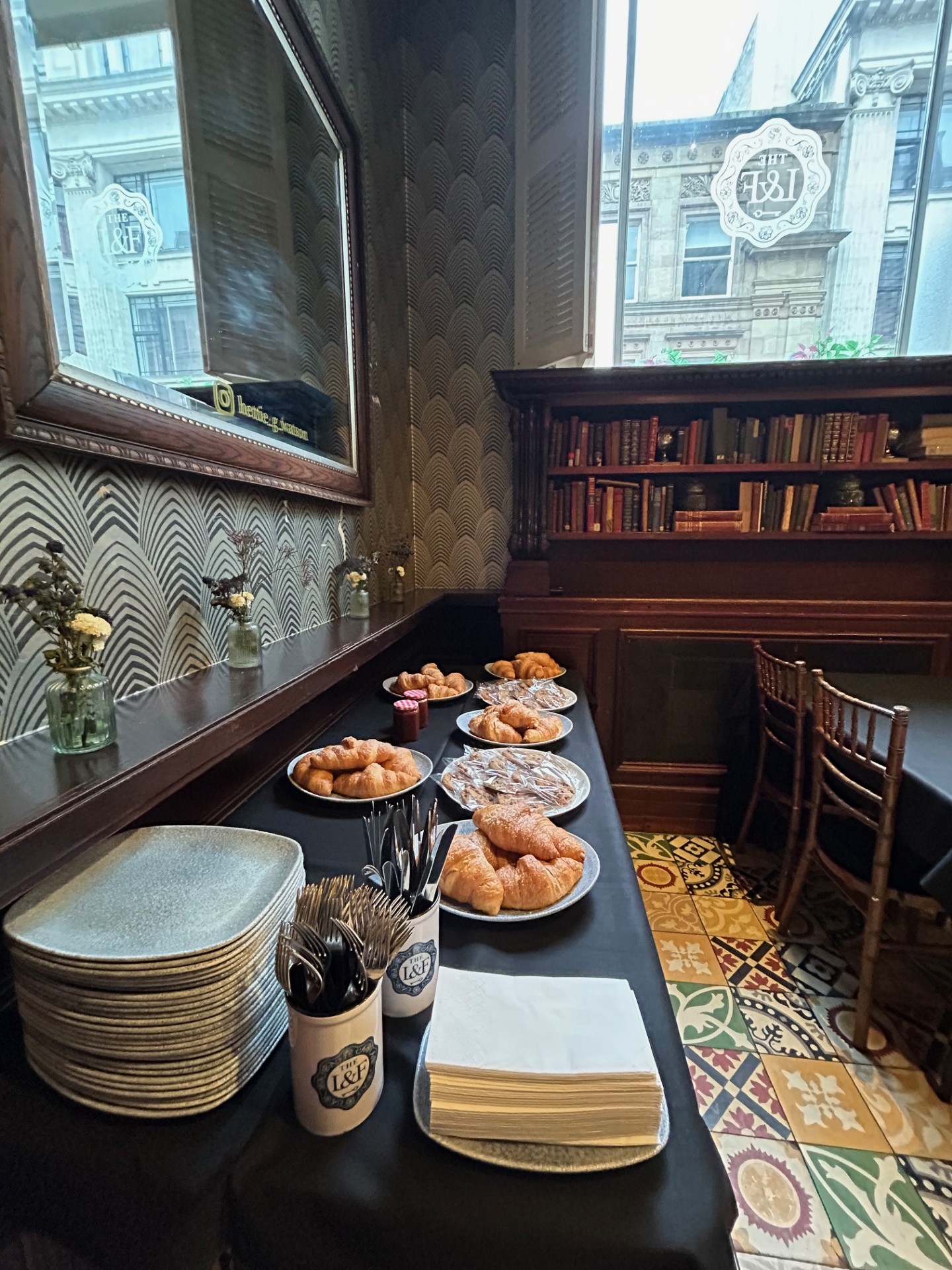 Boardroom breakfast setup with croissants at The Lost & Found Birmingham for corporate meetings.
