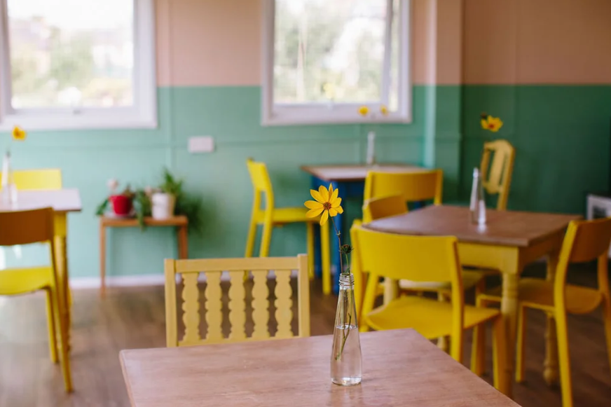 Vibrant meeting space with yellow chairs for team-building events at Abbotshall Centre