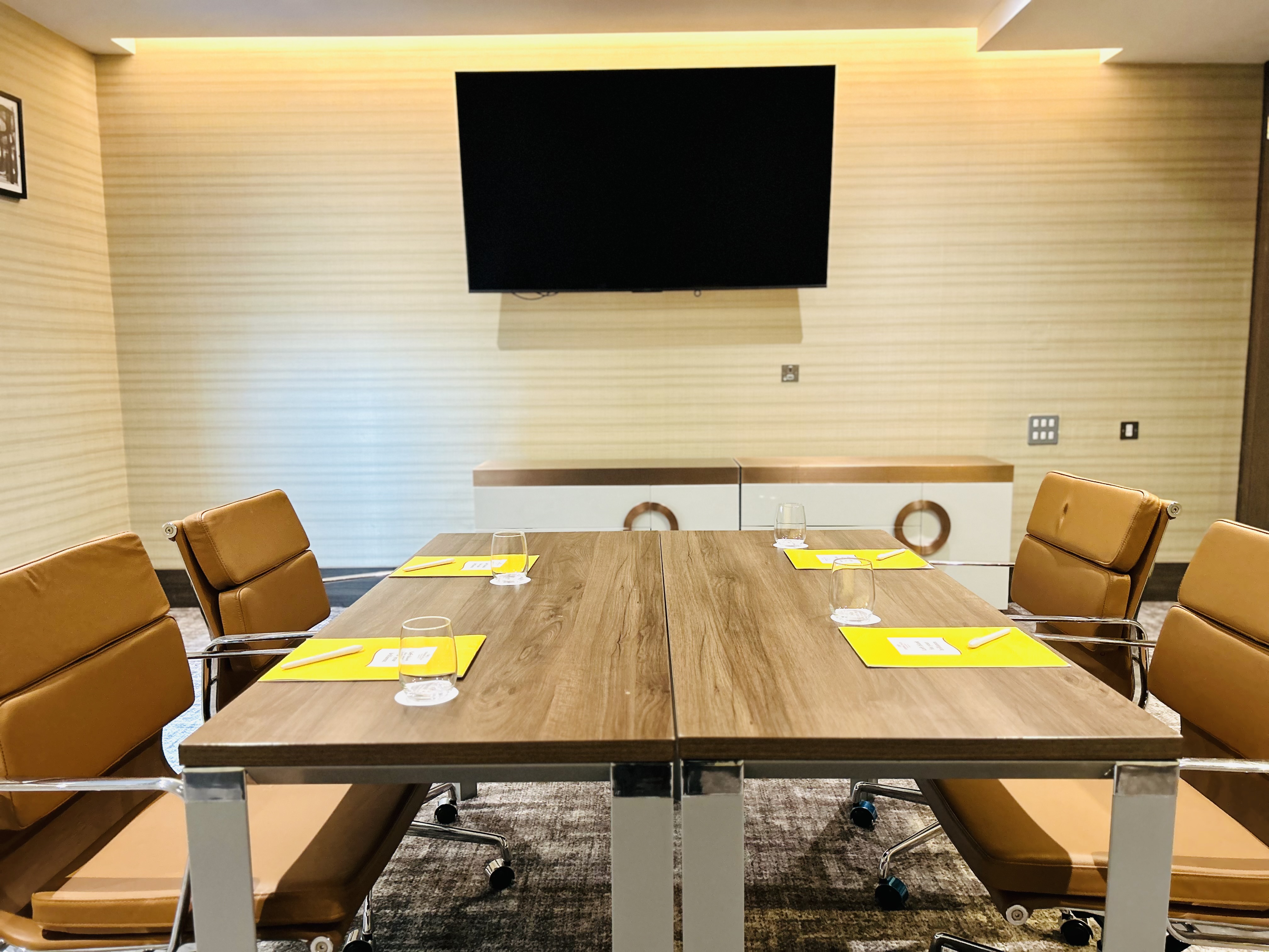 Richmond Suite conference room with sleek wooden table and leather chairs for meetings.