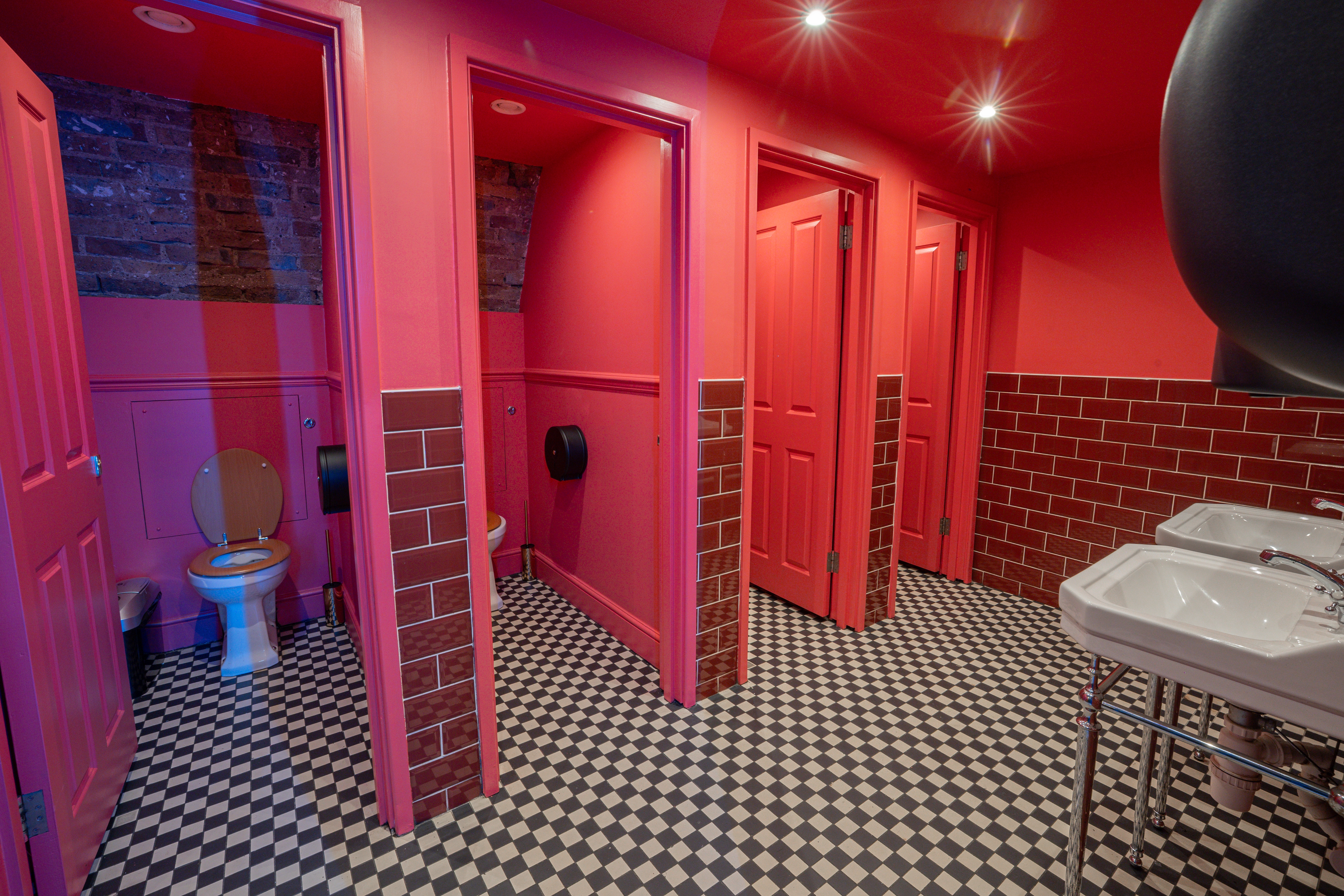 Bold pink restroom at DUO London, stylish venue for memorable events and meetings.