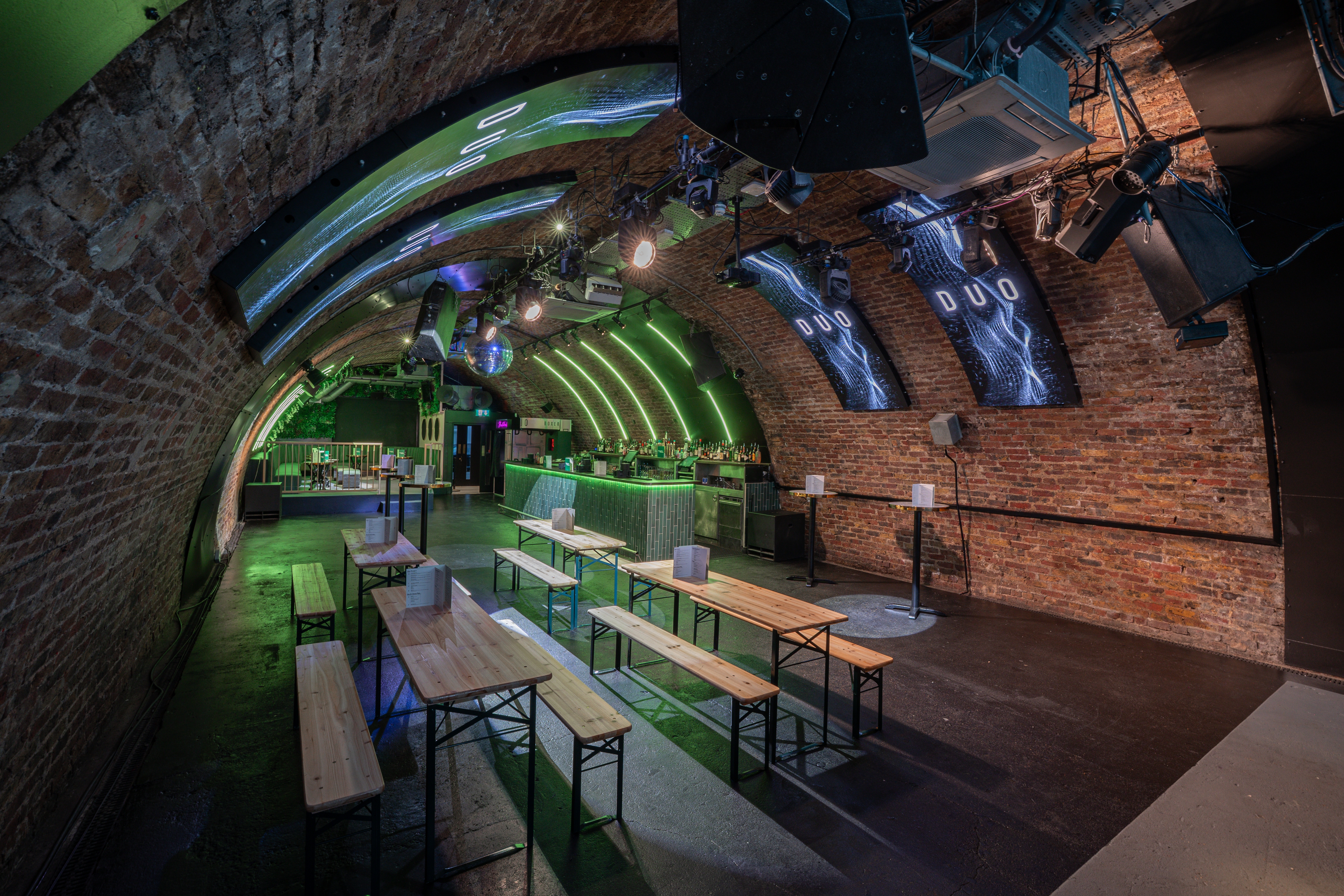 Stylish industrial event space at DUO London with arched brick walls for networking events.