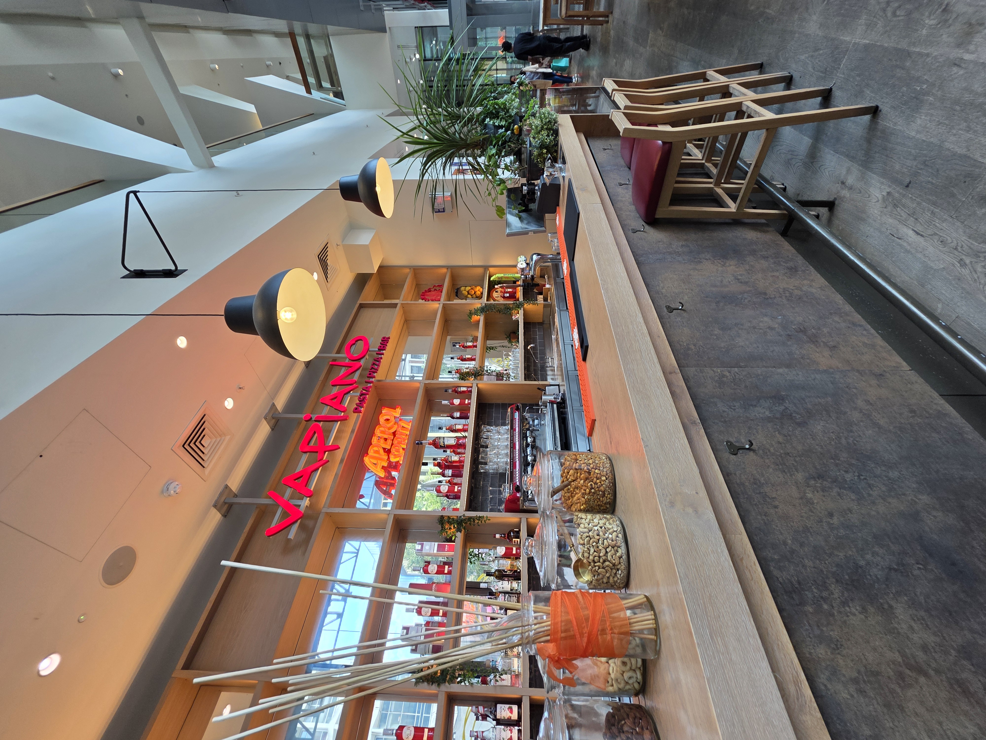 Vibrant Vapiano bar area, ideal for casual networking events and celebrations.