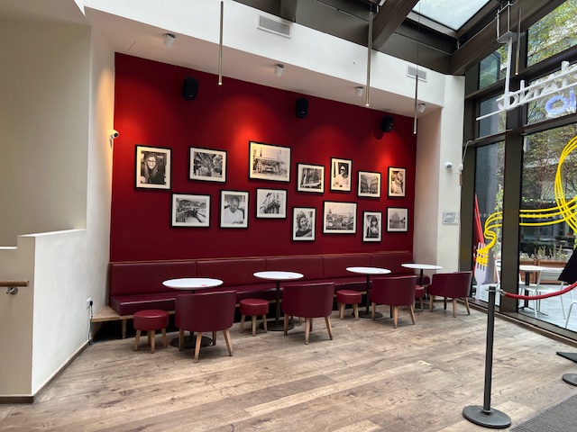 Stylish bar lounge at Vapiano Tower Bridge, featuring a red accent wall. Perfect for networking events.
