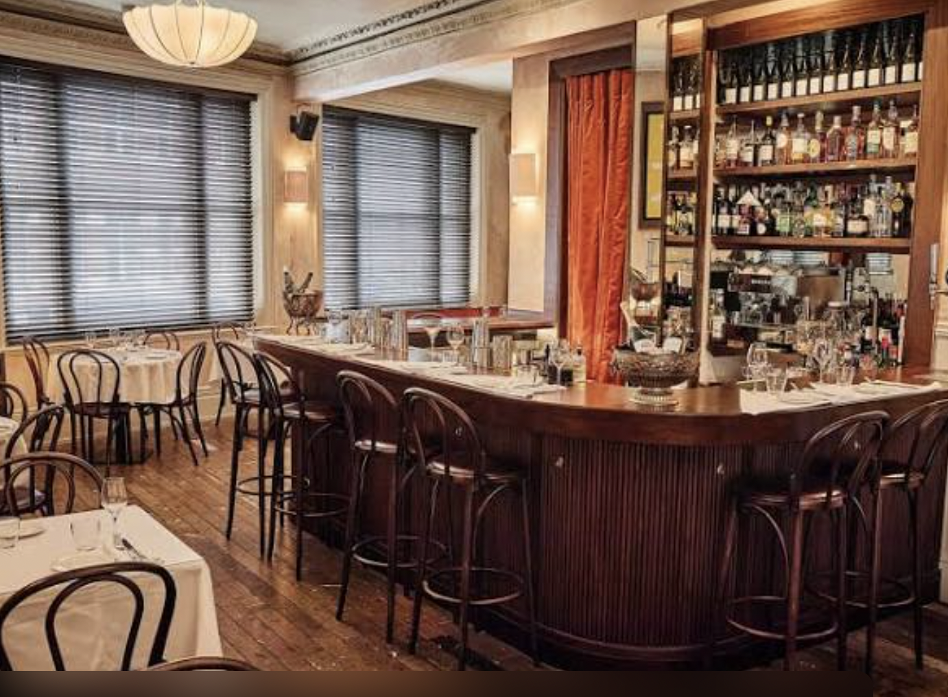 Sophisticated restaurant bar for events with warm lighting and ample seating.