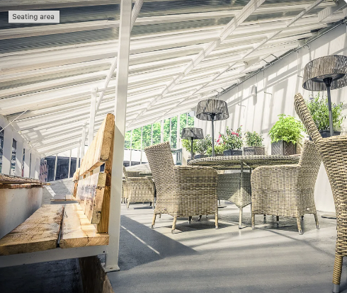 Outdoor meeting space in Walled Garden West Wycombe with wicker furniture, perfect for networking events.