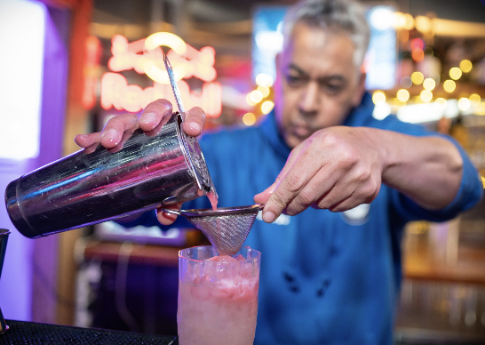 Bartender crafting cocktails at Exclusive Venue Hire, Chelsea Winter Village event.