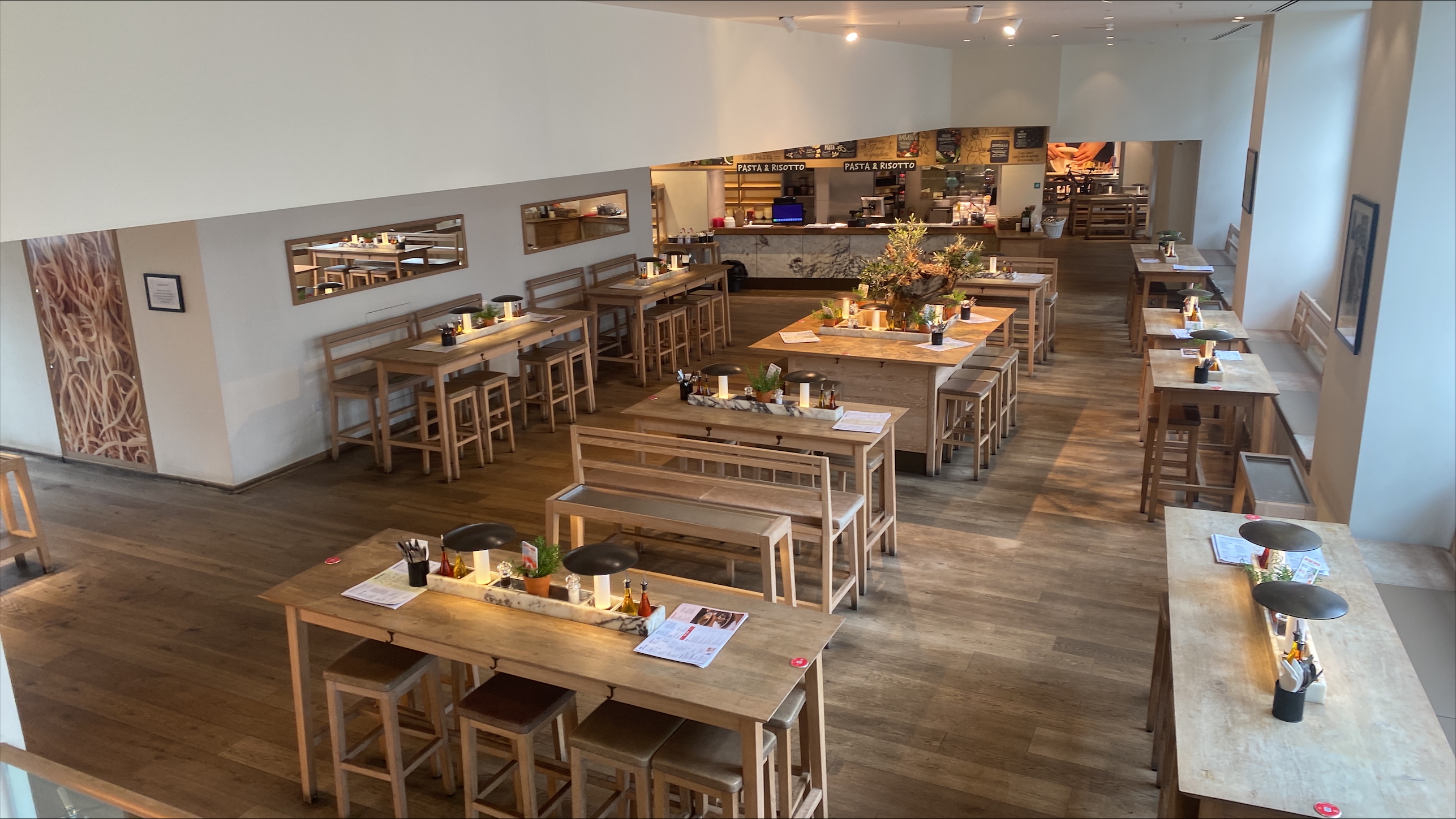 Spacious venue hire with communal tables for events in Vapiano, Manchester.