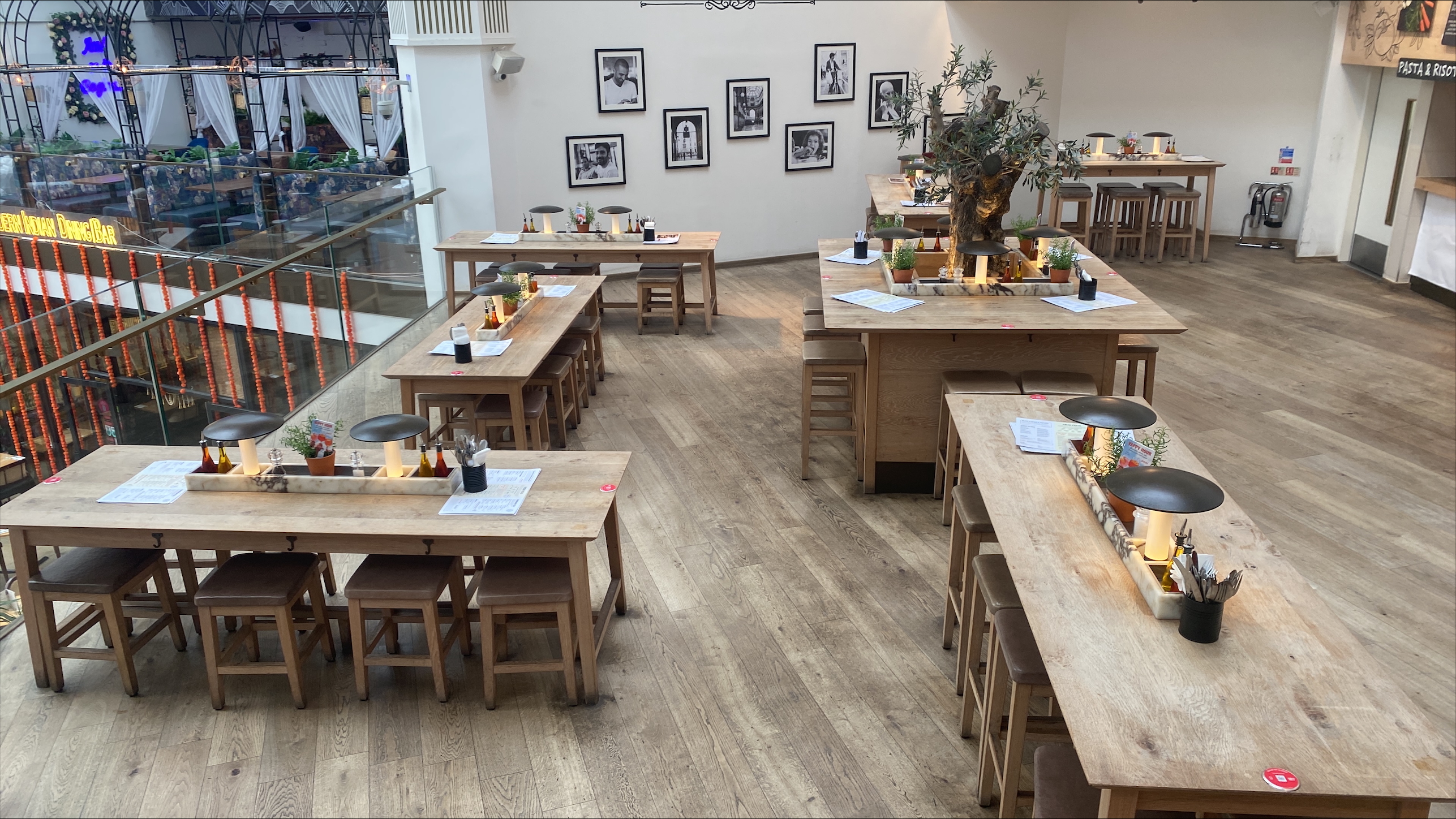 Spacious Vapiano venue in Manchester with wooden tables for networking events