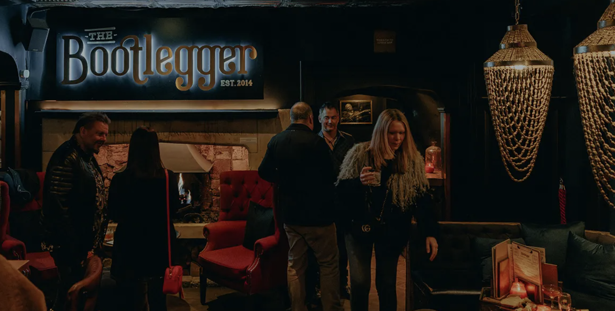 Full venue hire at Bootlegger Bath with fireside decor for upscale networking event reception.