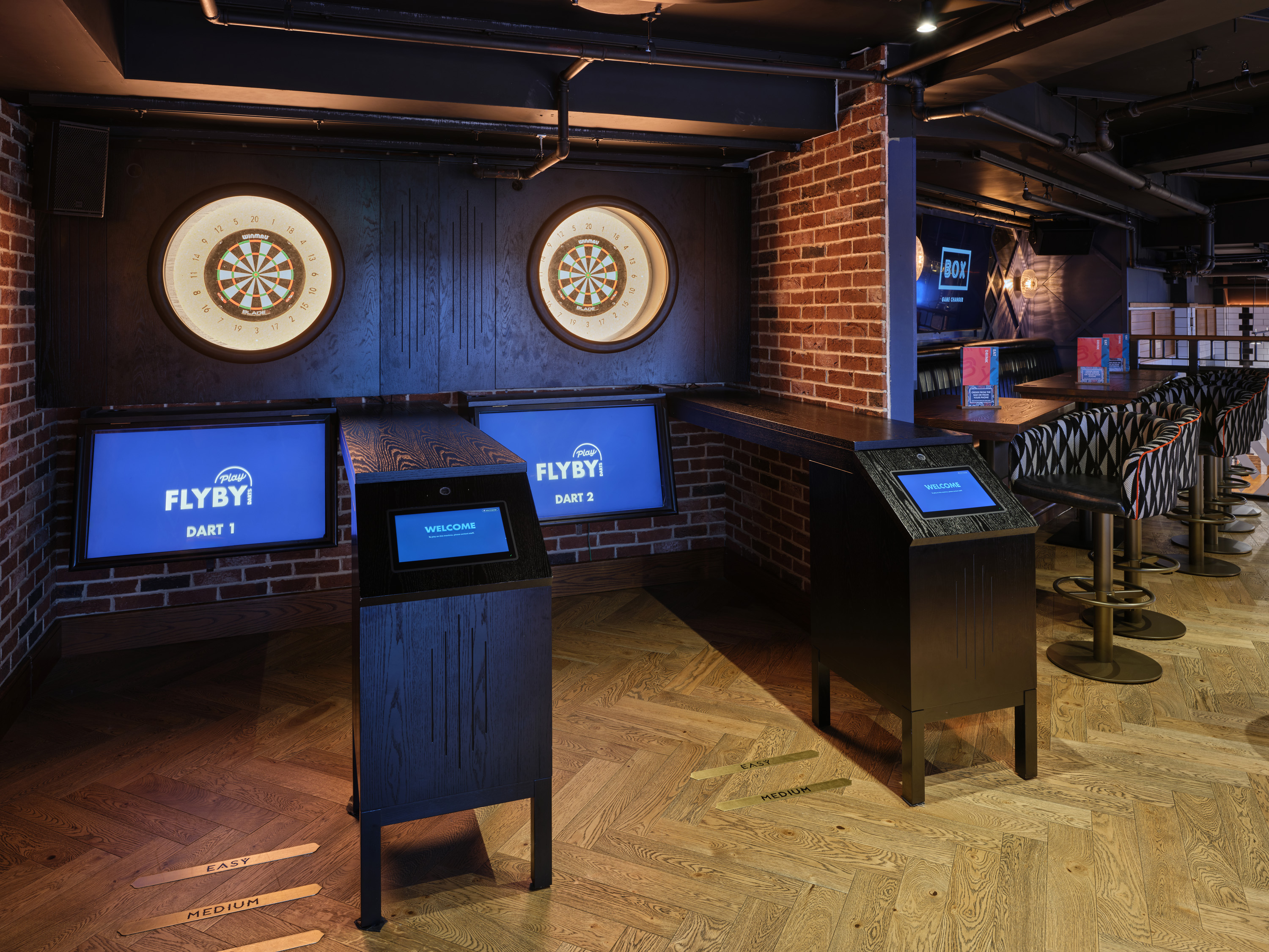 Modern BOX Piccadilly venue with dartboards, ideal for team-building events and networking.