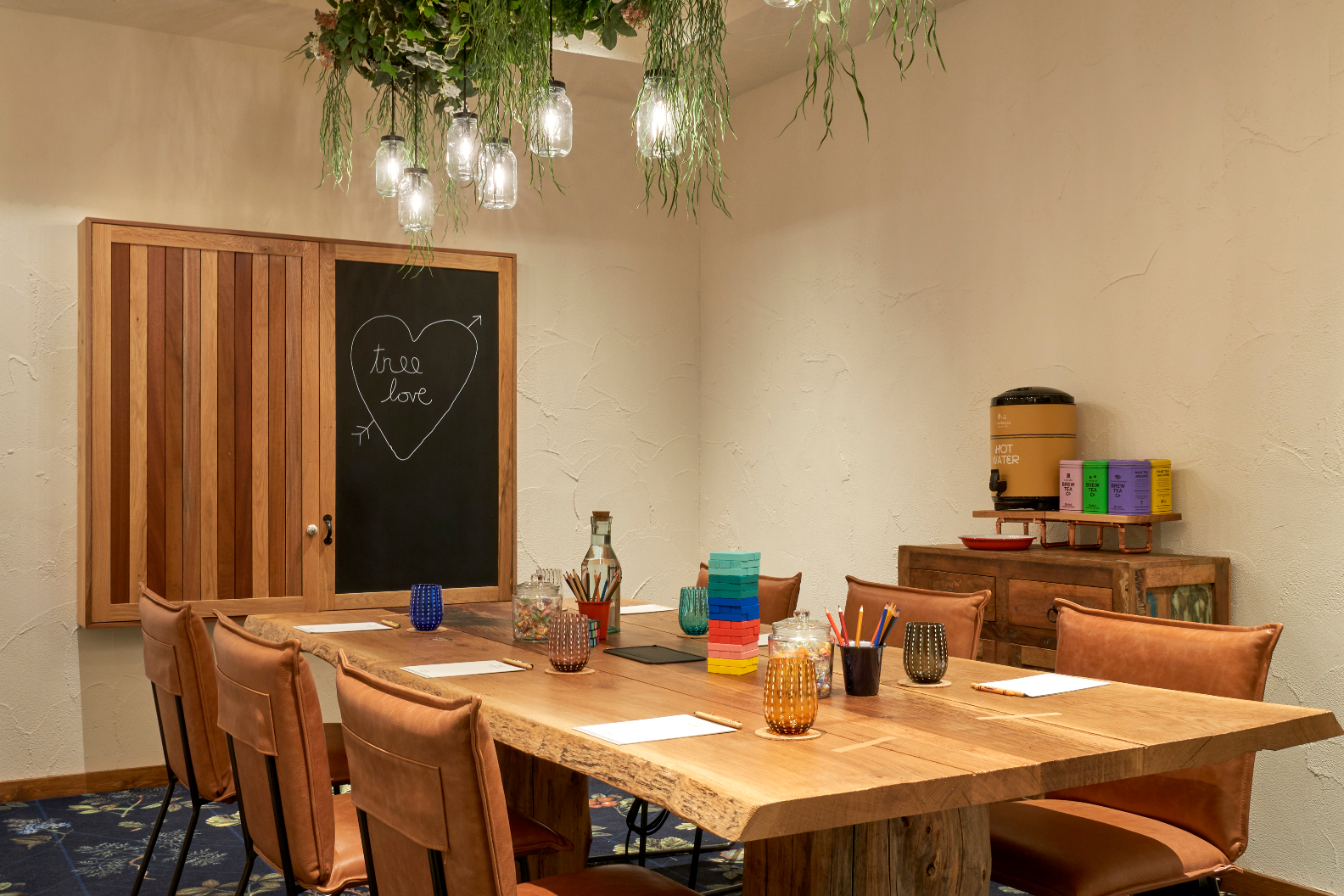 Acorn meeting space at Treehouse Hotel Manchester, featuring a rustic table for workshops.