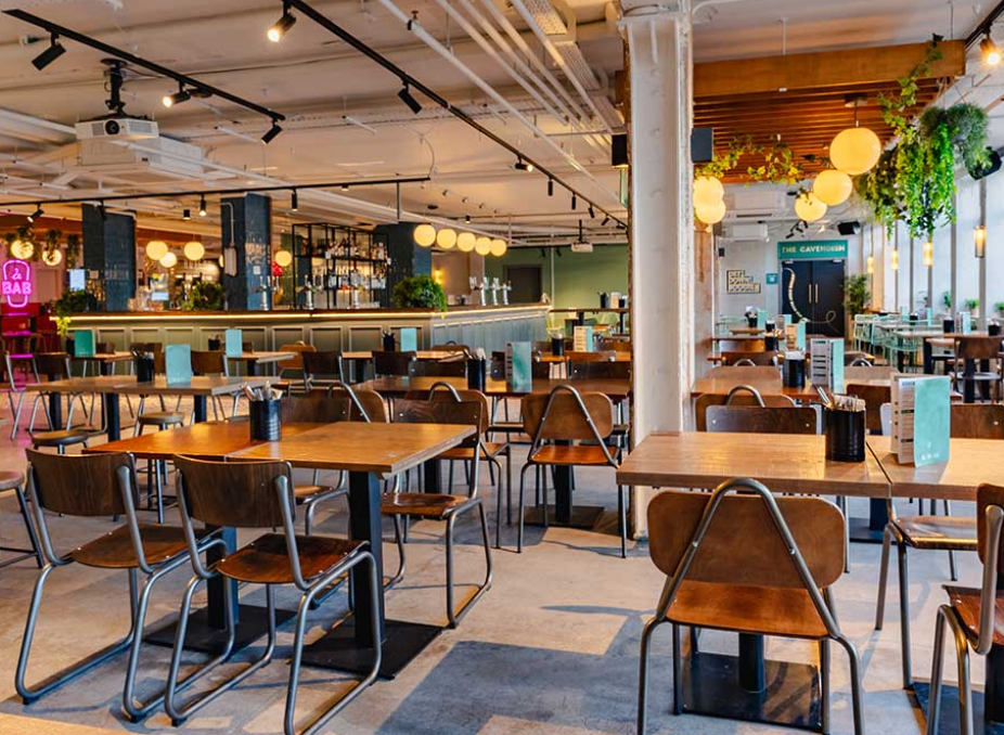 Industrial-chic event venue with bar for corporate mixers and networking.