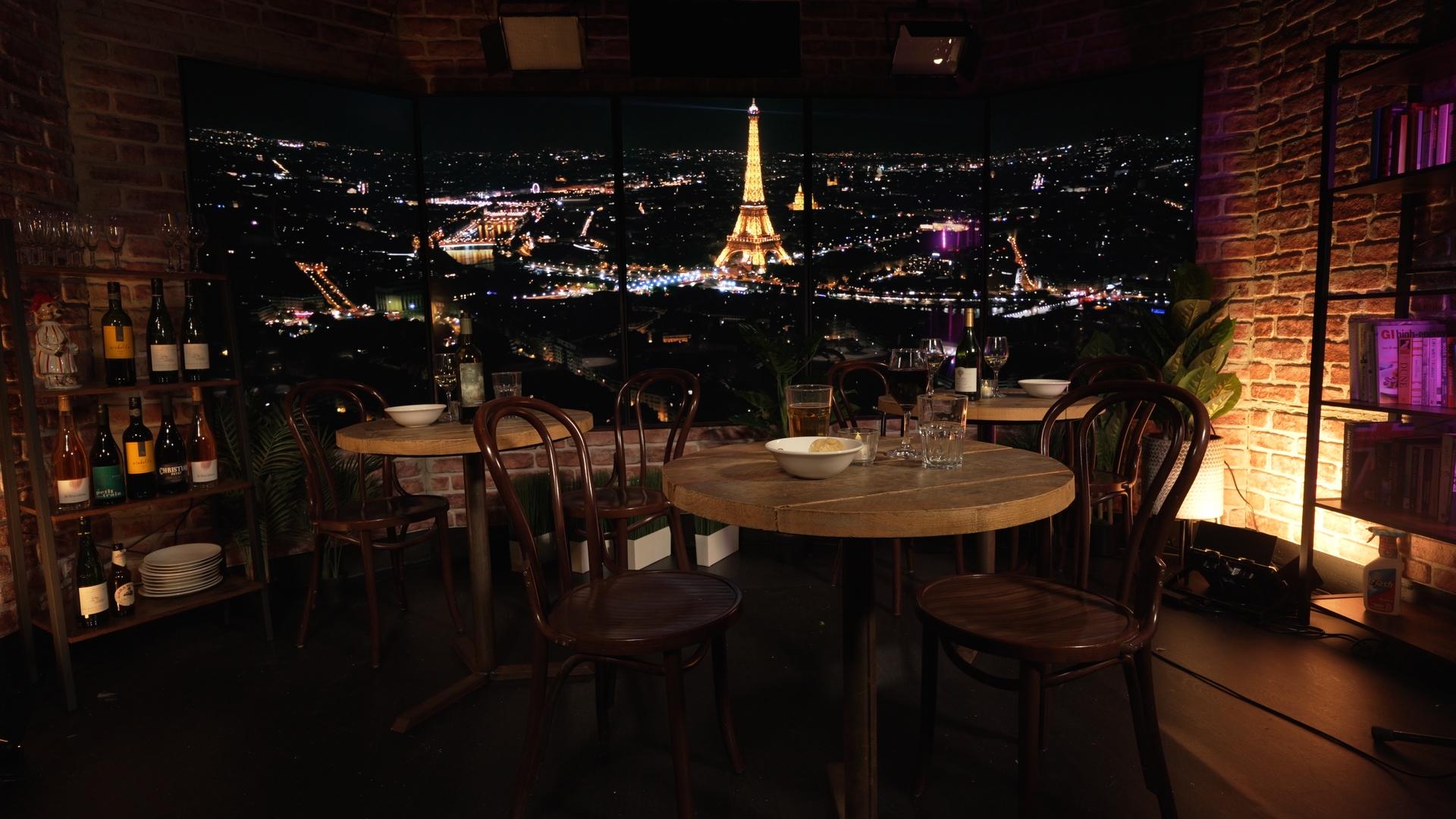 Intimate event space with Eiffel Tower backdrop for upscale dinners and networking.