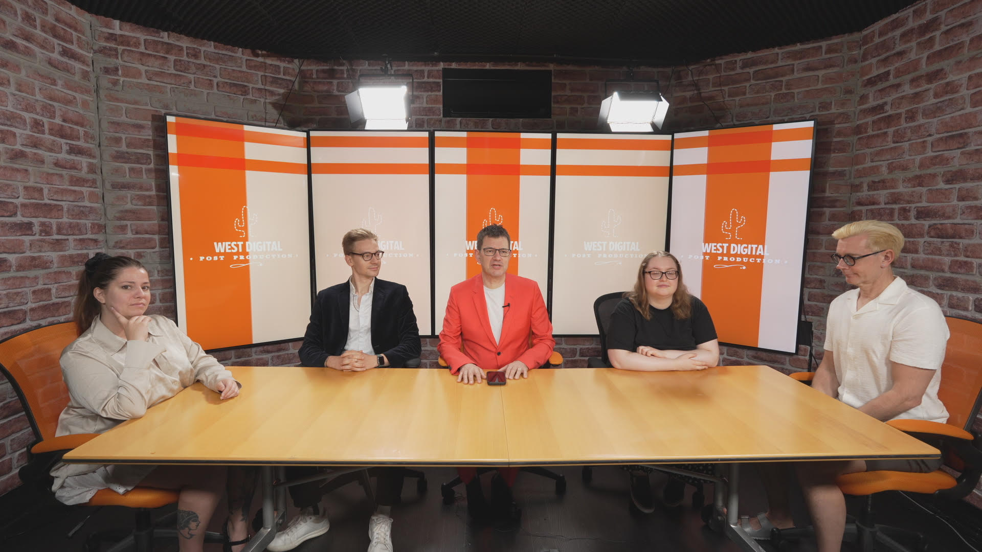 Broadcast studio panel discussion setup with professional branding and engaging lighting.