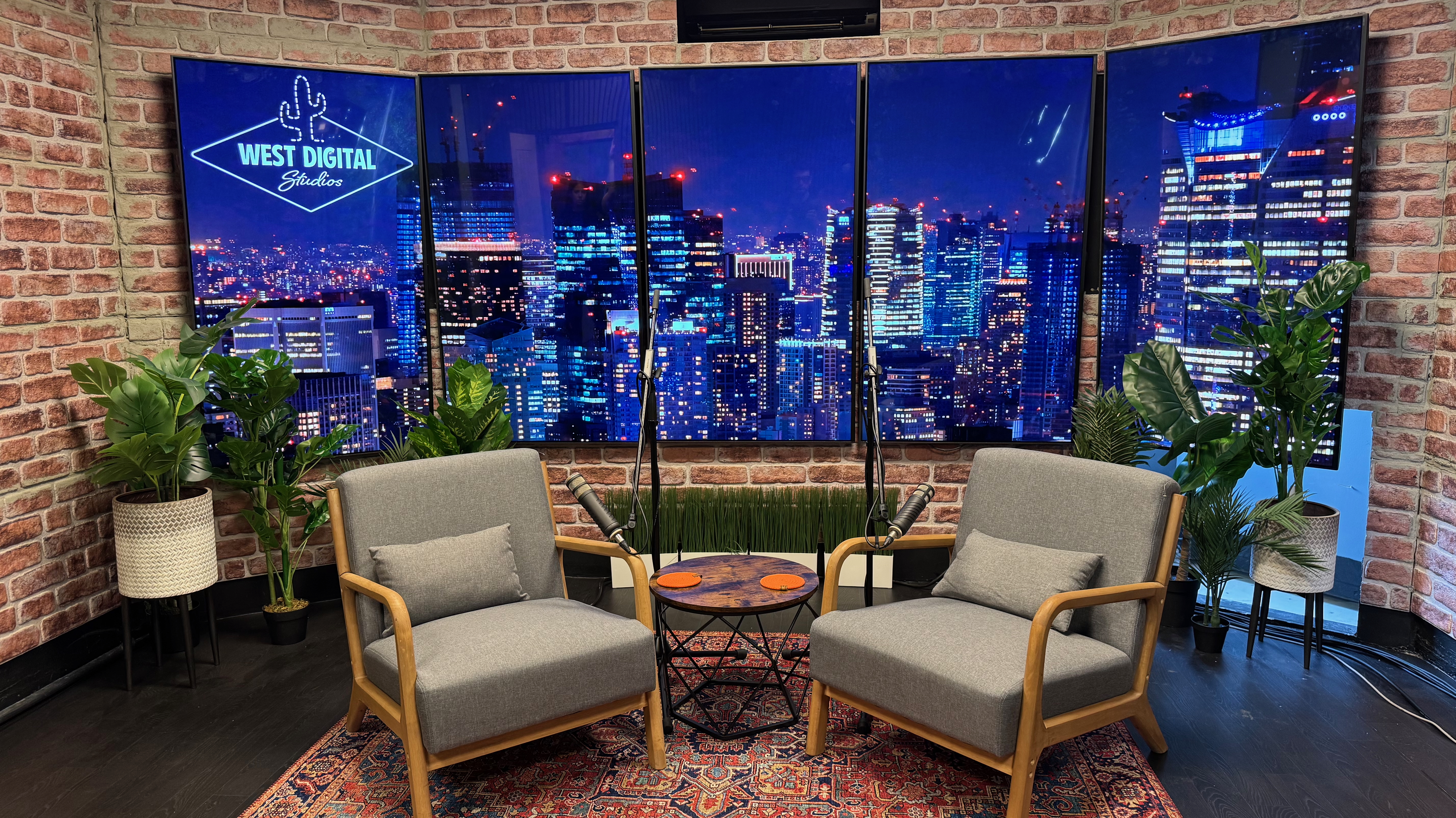 Modern podcast studio with city skyline backdrop, ideal for networking events.