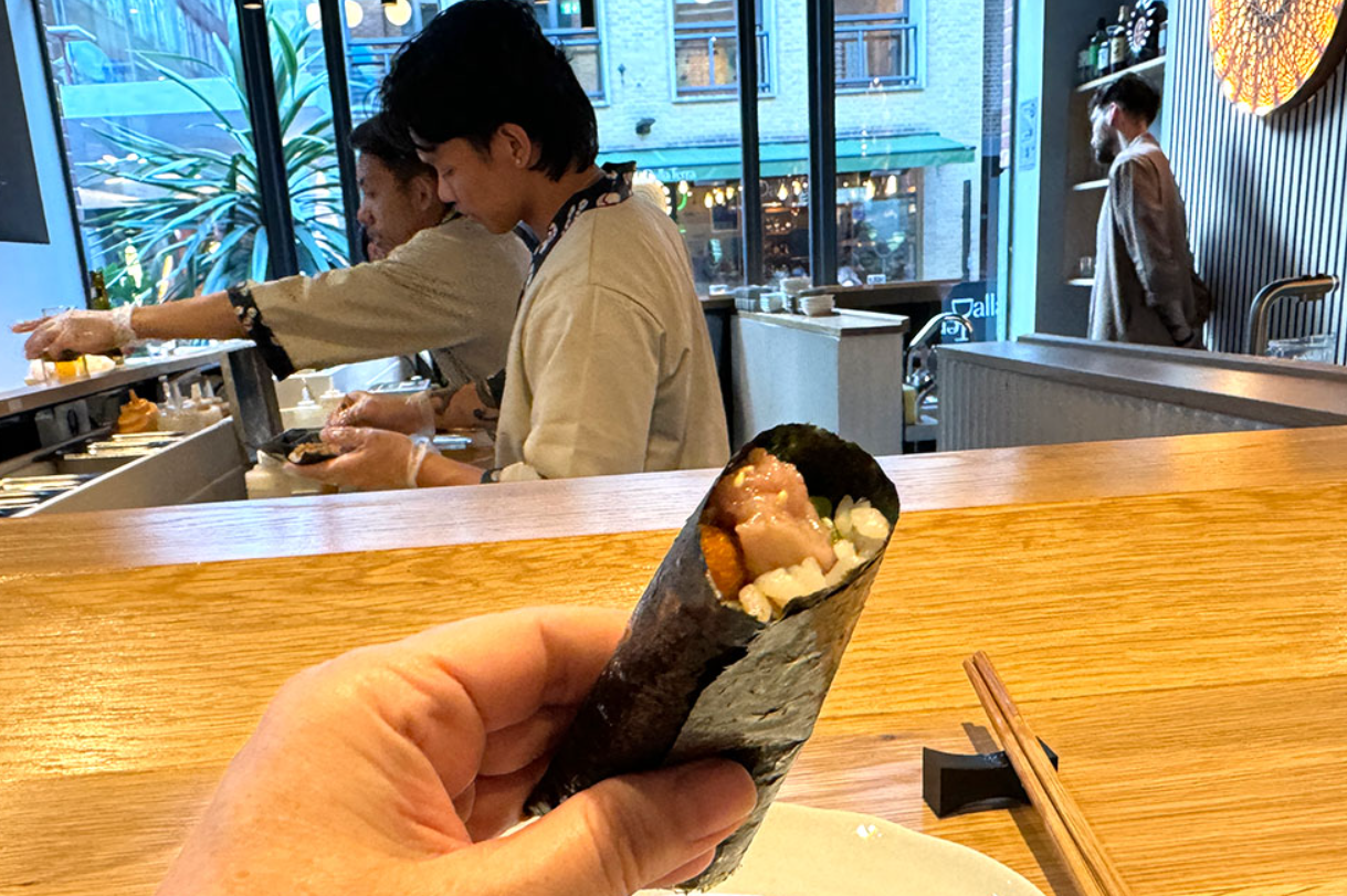 Sushi chef preparing rolls at Ukiyo Hand Roll Bar, ideal for catering and networking events.