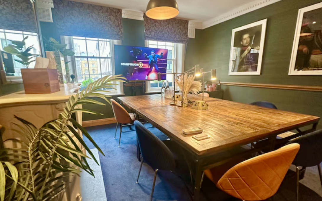 Boardroom at Starstruck HQ with wooden table, modern tech for meetings and presentations.