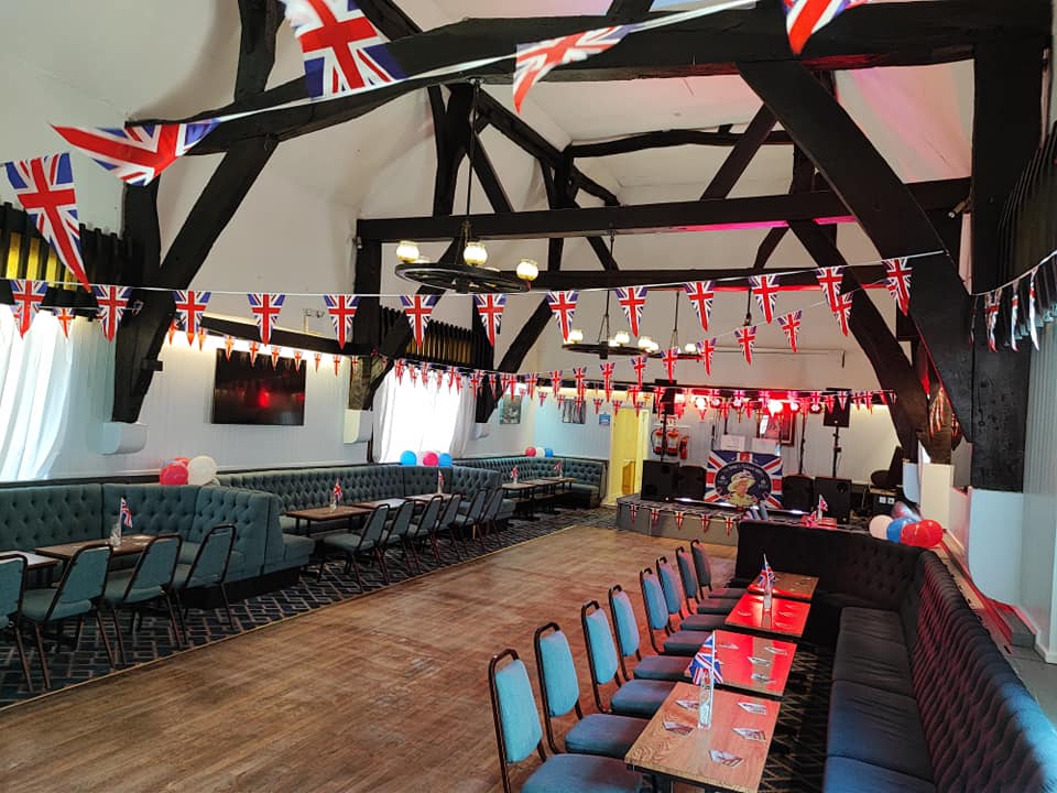 "Tythe Barn festive event space with colorful decor for celebrations and meetings."