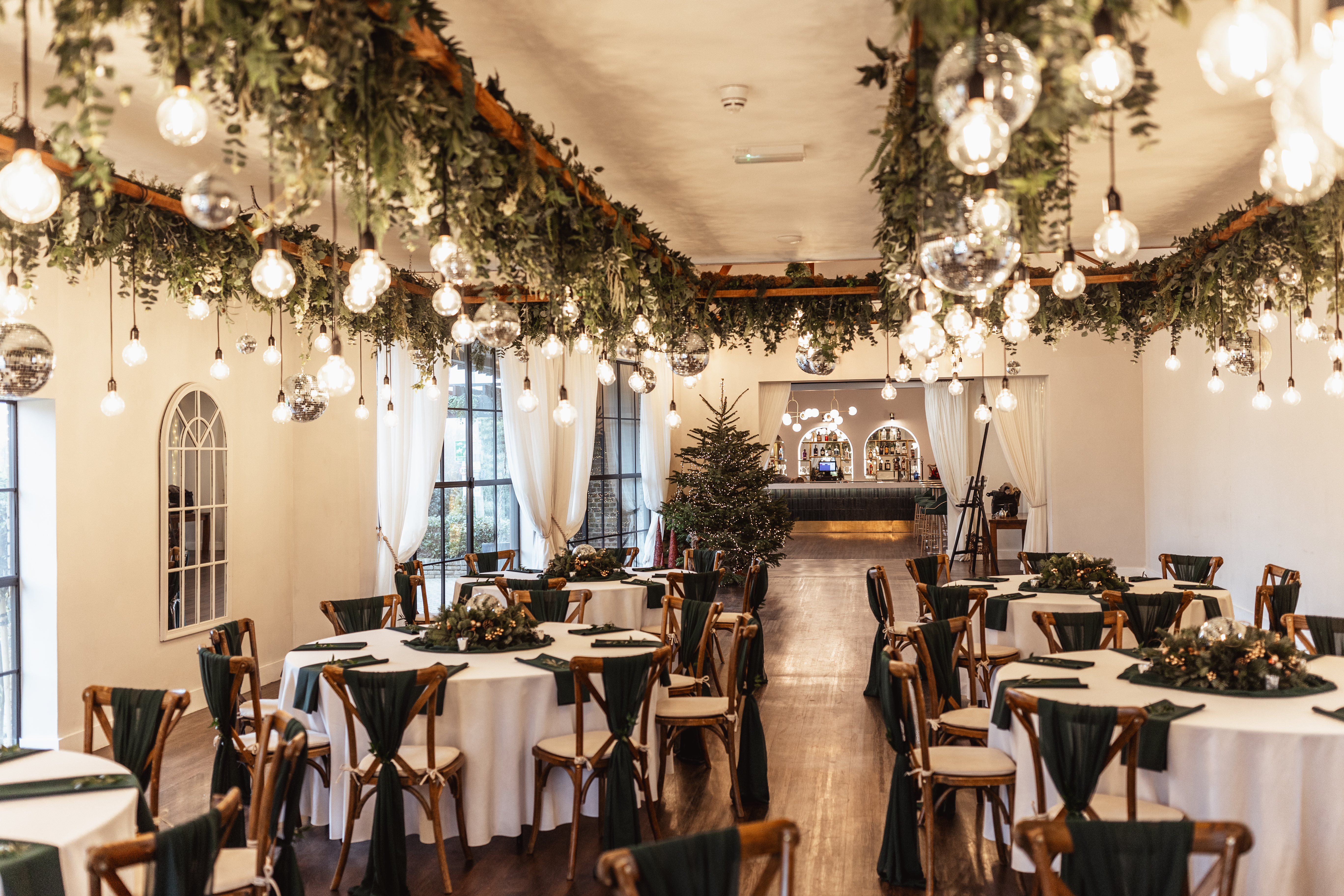 Elegant event space with greenery for Ultimate Christmas Night festivities.