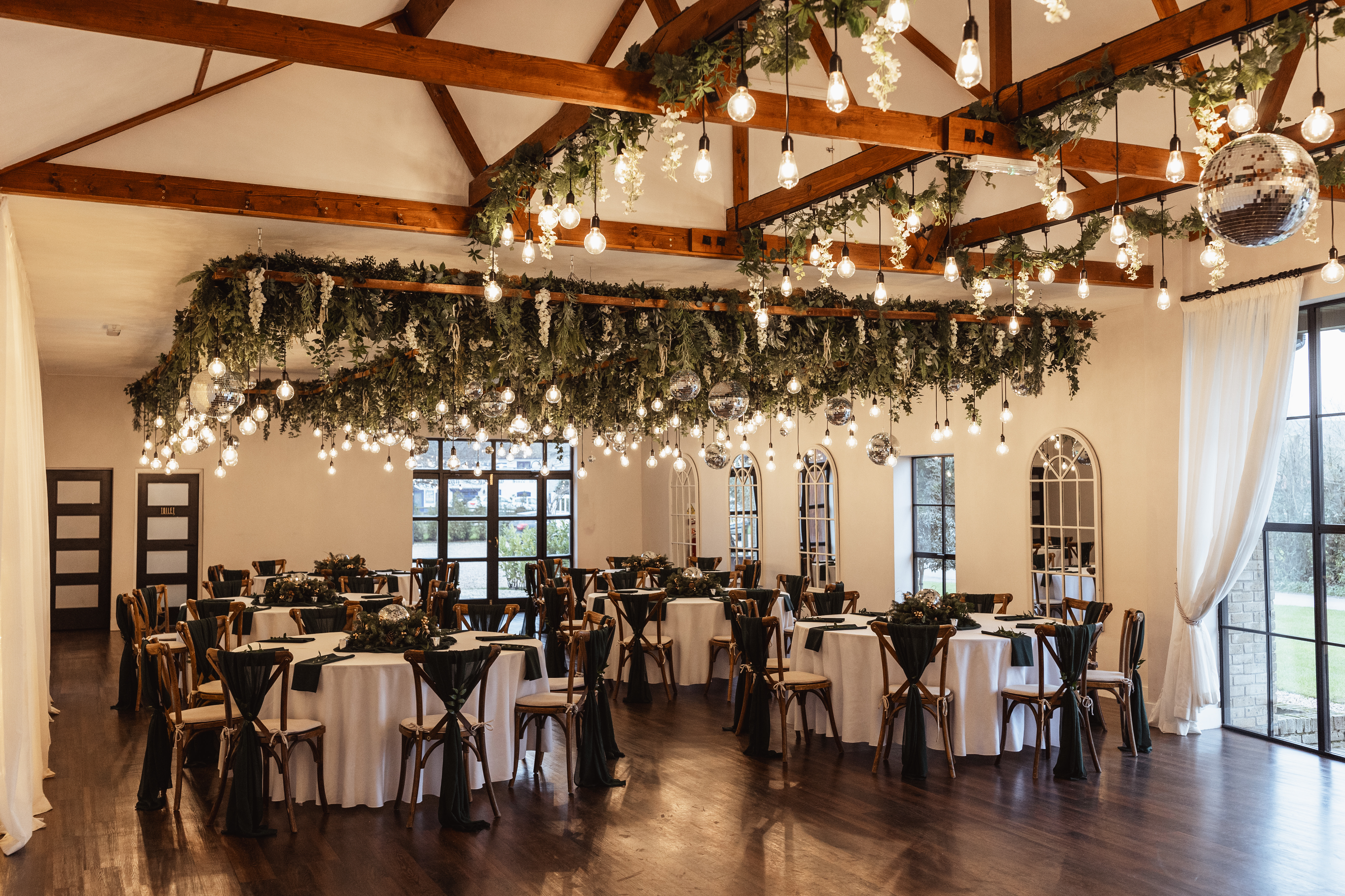 Elegant event venue with round dining tables for weddings and formal gatherings.