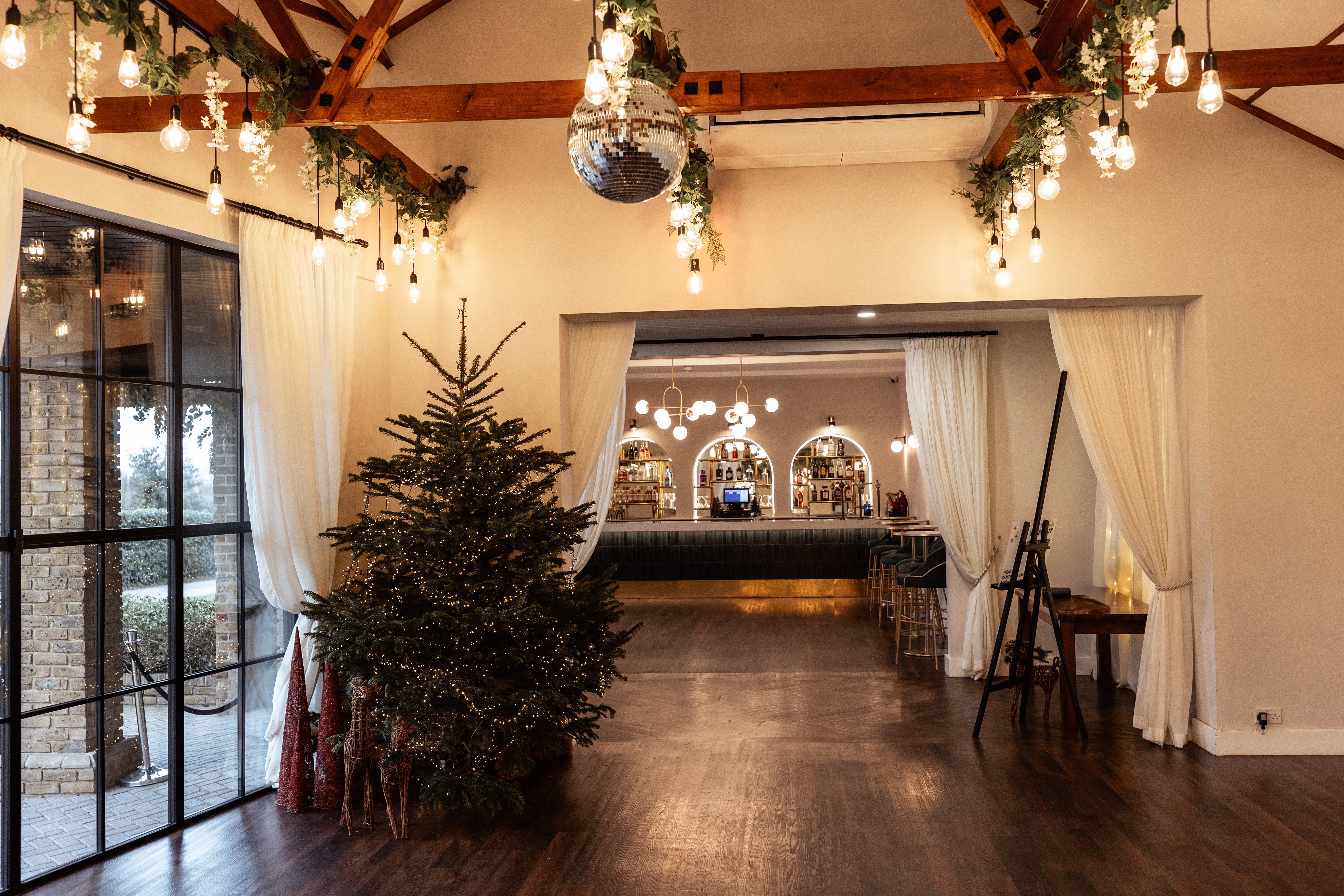 "Ultimate Christmas Night at Oad Street Events Venue with rustic beams and festive decor."