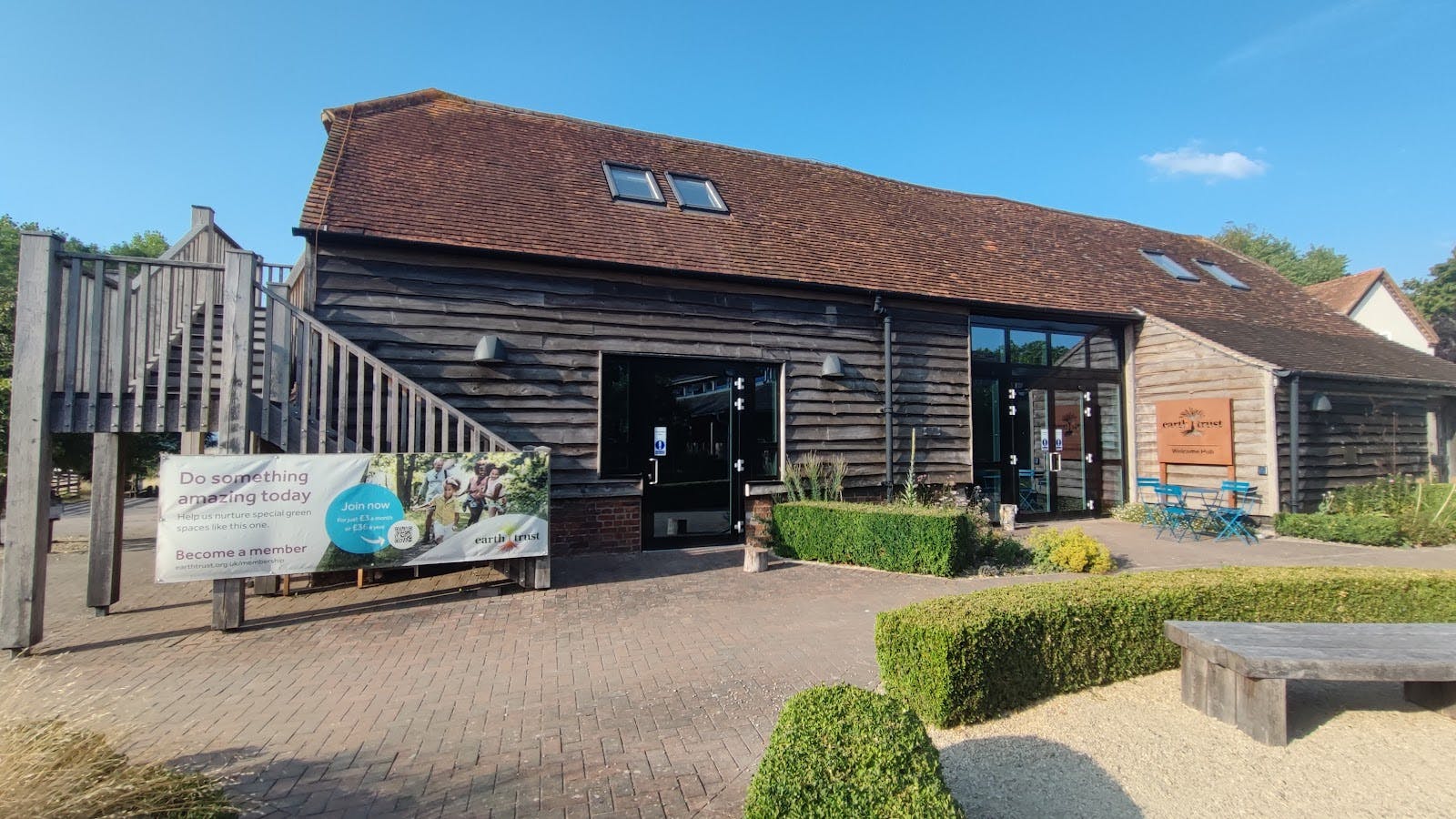 Rustic event venue Courtyard at Earth Trust with wooden architecture for corporate retreats.