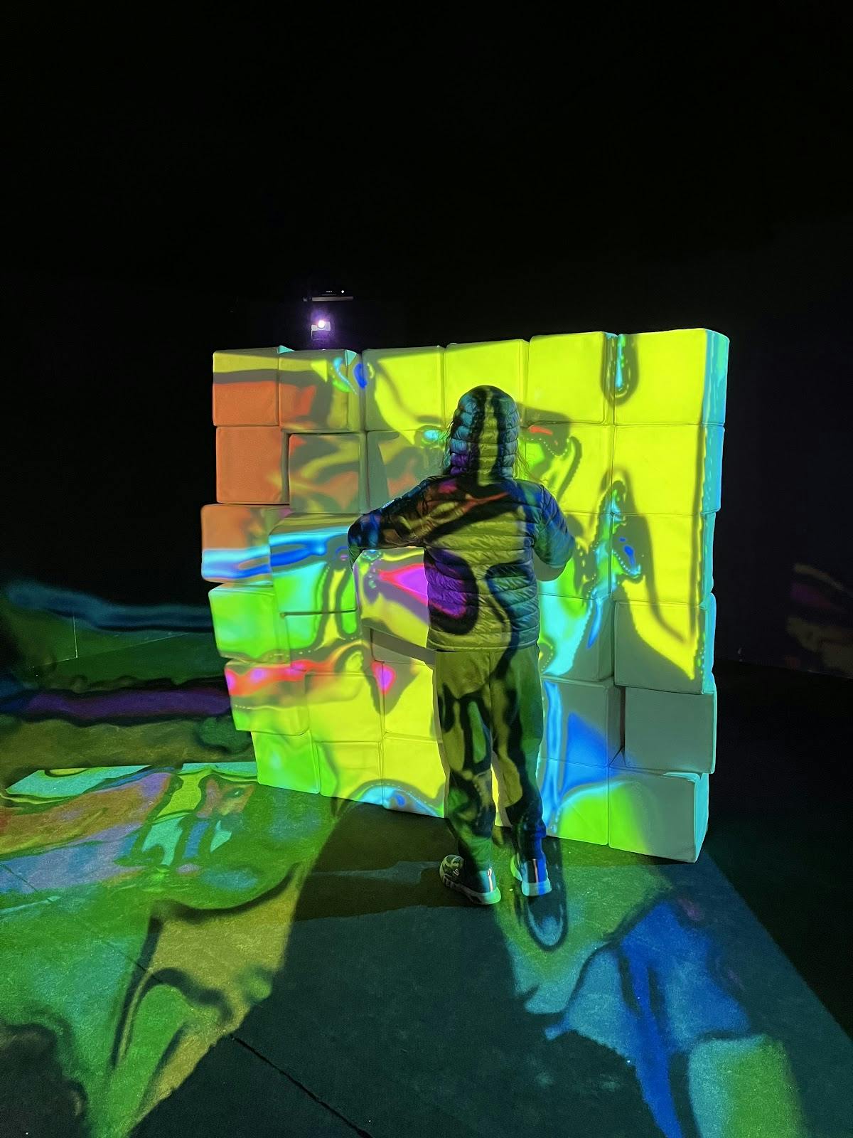 Rooftop bar interactive installation with vibrant illuminated backdrop for events.