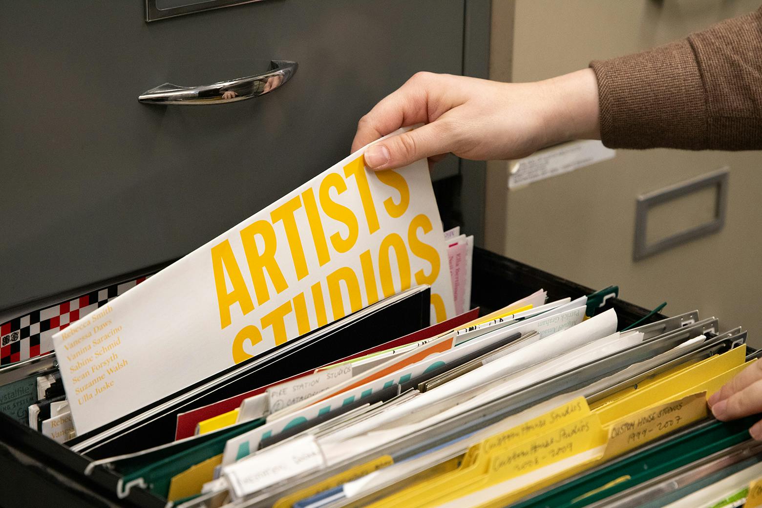 Well-organized filing system in NICOLA Arts studio for event planning and collaboration.