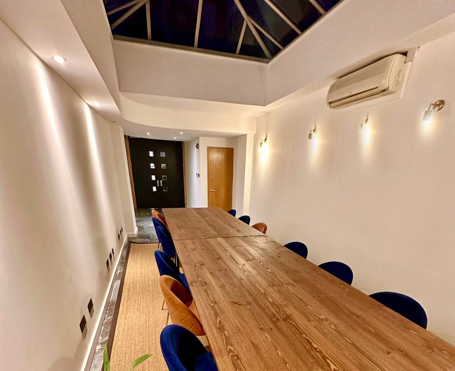 Minimalist meeting room with wooden table at Starstruck HQ for collaborative events.
