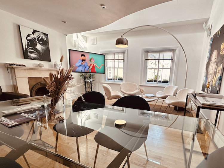 Modern meeting space in Starstruck HQ with a sleek glass table for corporate events.
