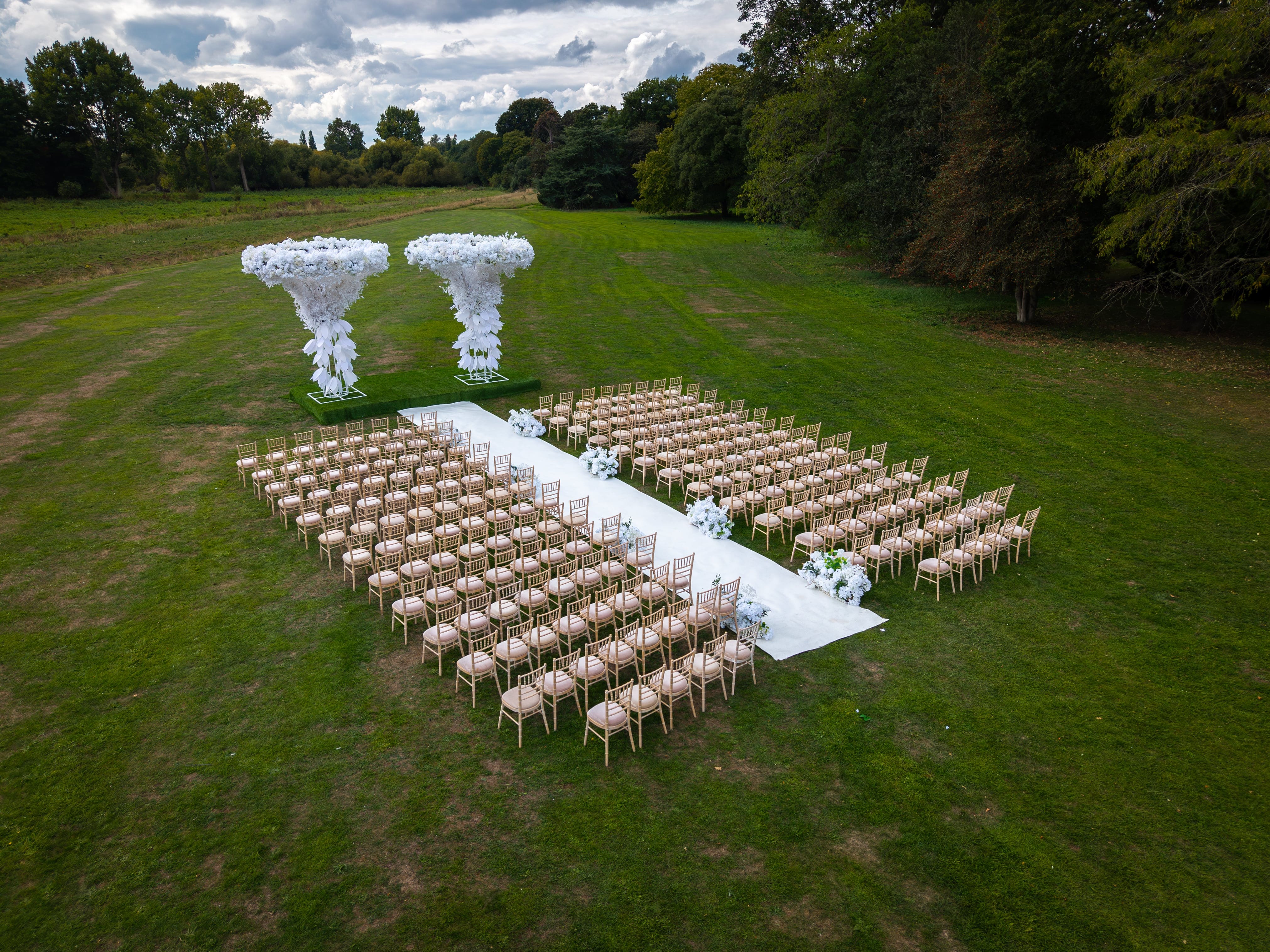 Elegant outdoor wedding setup at The Clementine, Syon Park with floral altar.