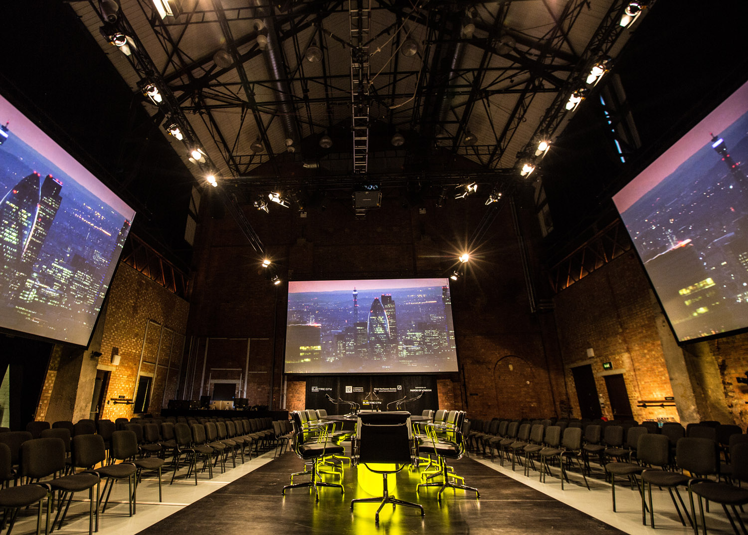Modern event space in Shoreditch with black chairs, ideal for conferences and presentations.