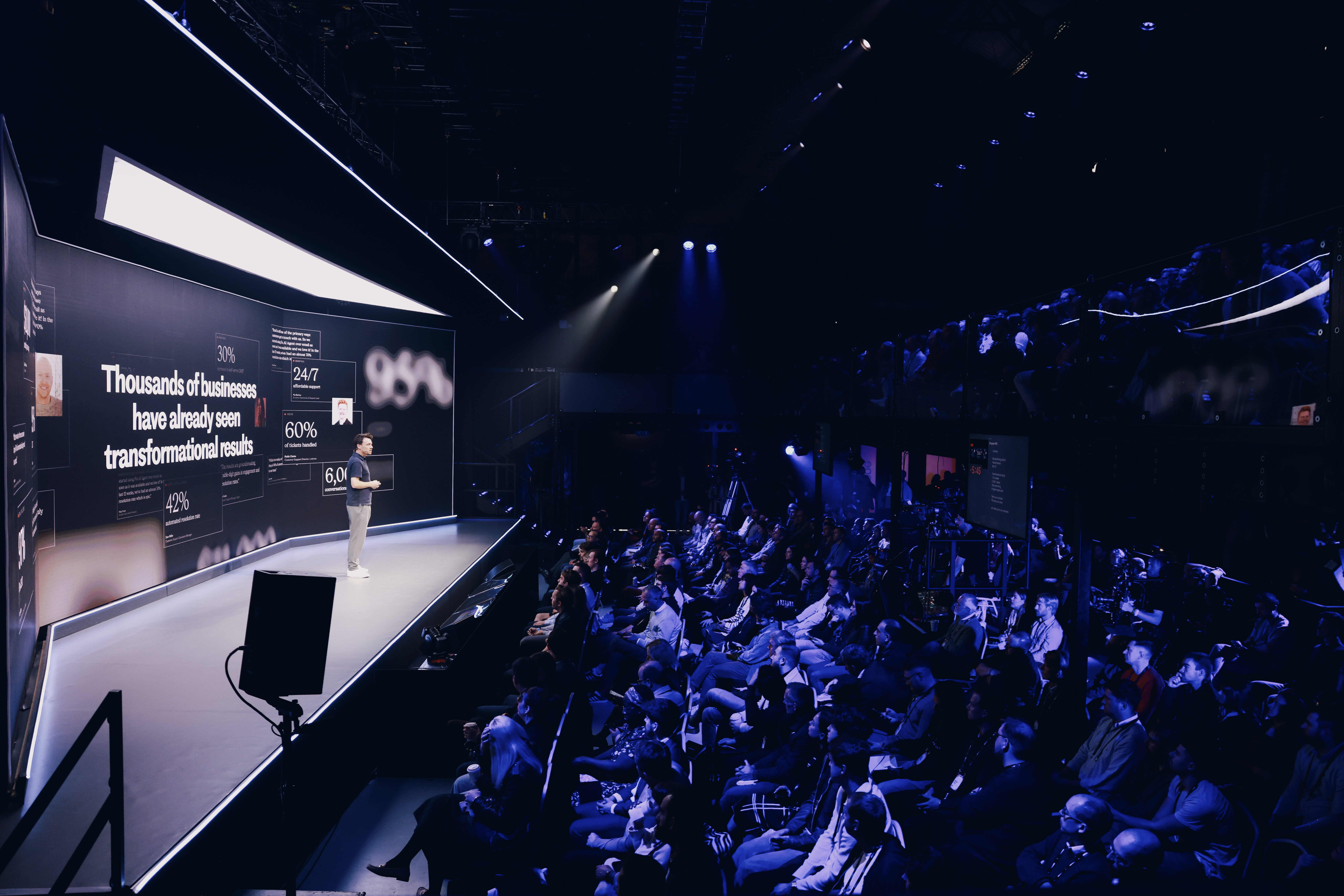 Conference speaker engaging audience on a well-lit stage in Shoreditch Electric.