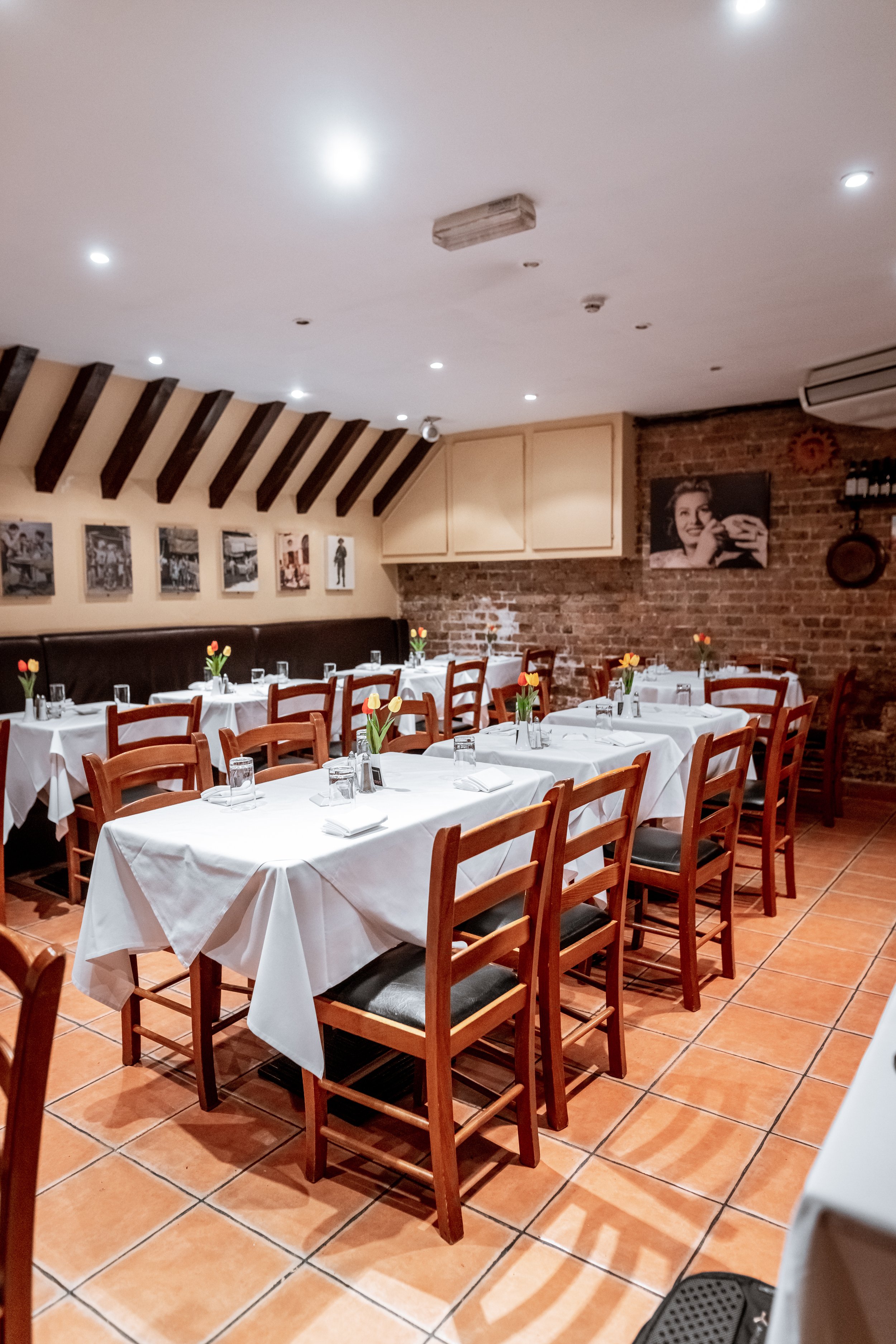 Intimate dining space with white linens at Sarracino Italian Restaurant for private events.