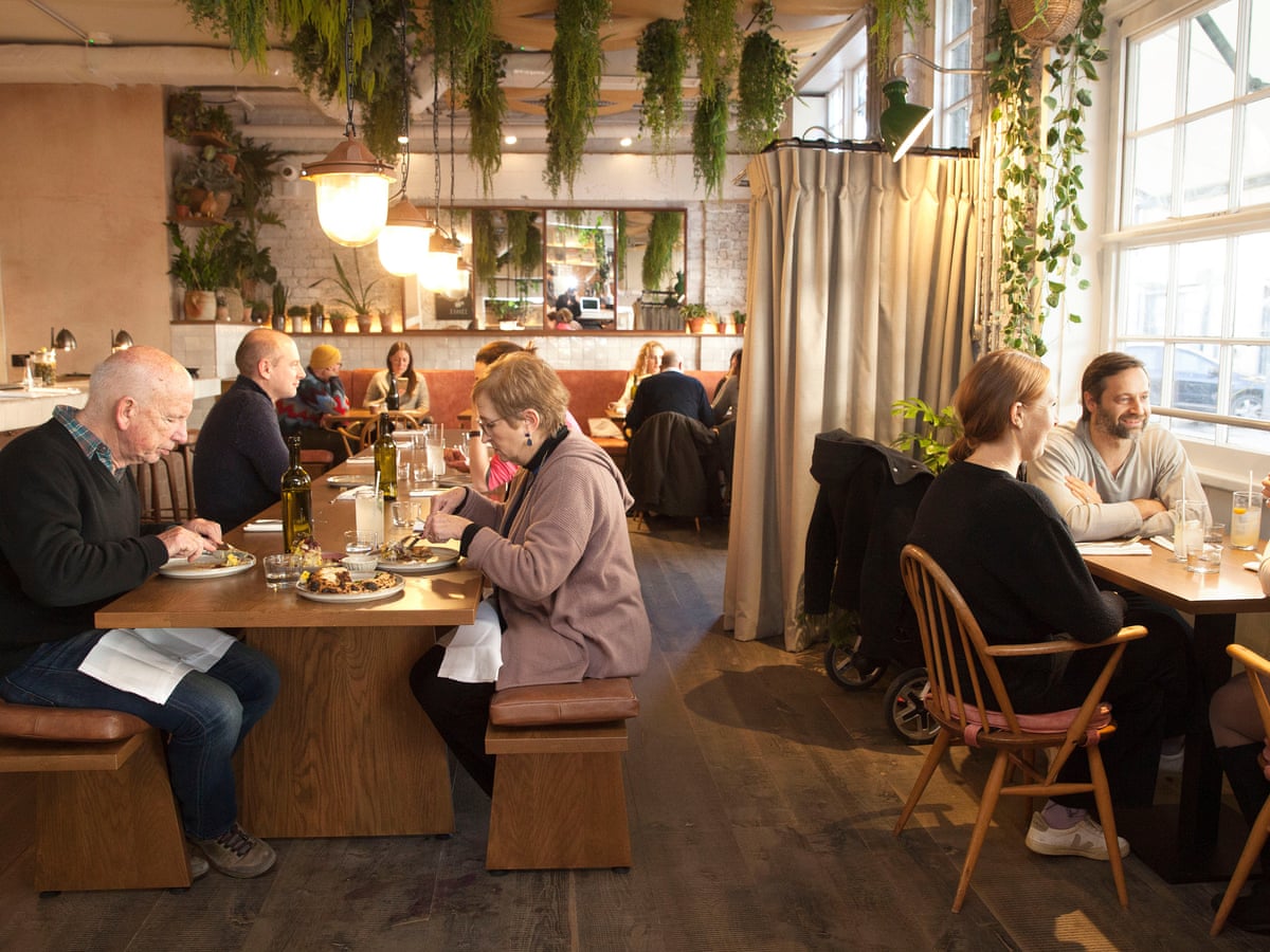 Vibrant dining space in Queen's Quarters for meetings and events, featuring warm lighting.