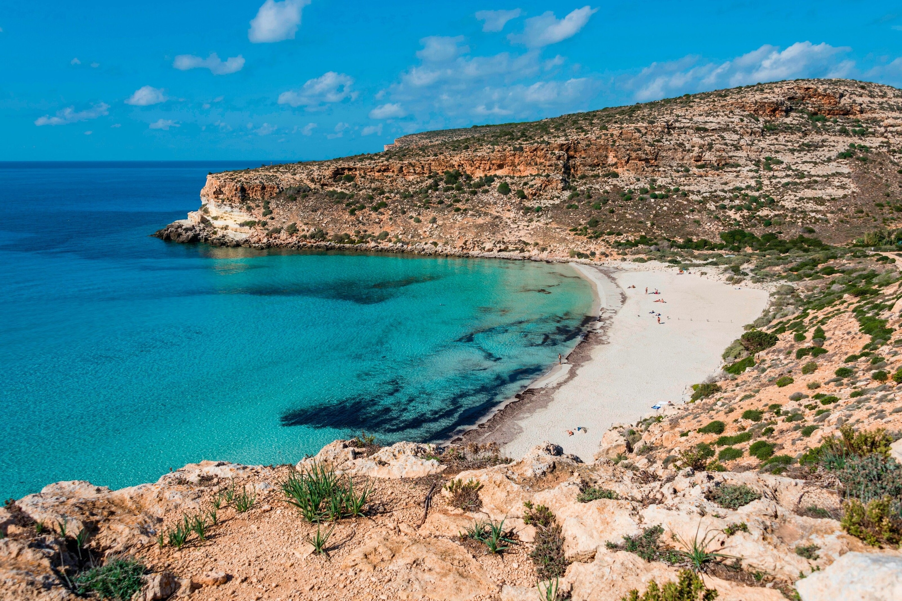 Clifftop Terraces & Salon: rugged cliffs, turquoise waters, ideal for outdoor retreats.