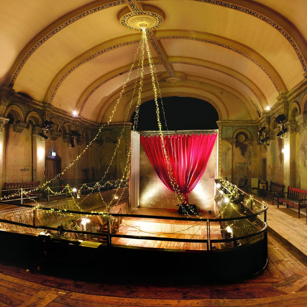 Elegant ballroom venue with pink curtains, perfect for chic events and galas.