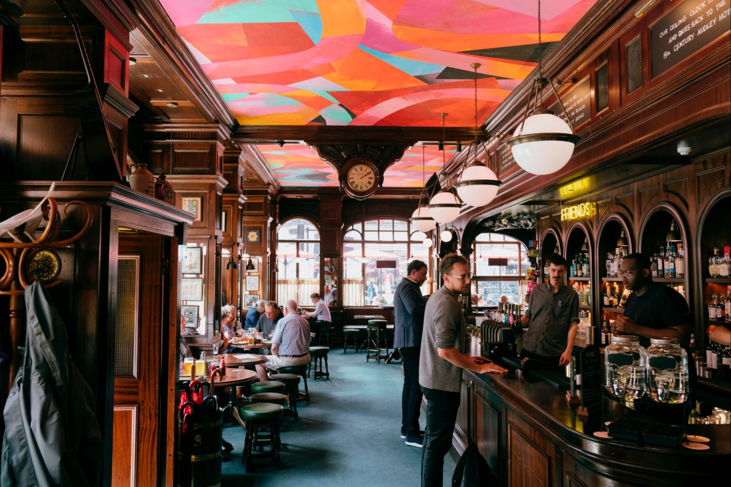 Vibrant pub venue with colorful ceiling art for informal gatherings and events.