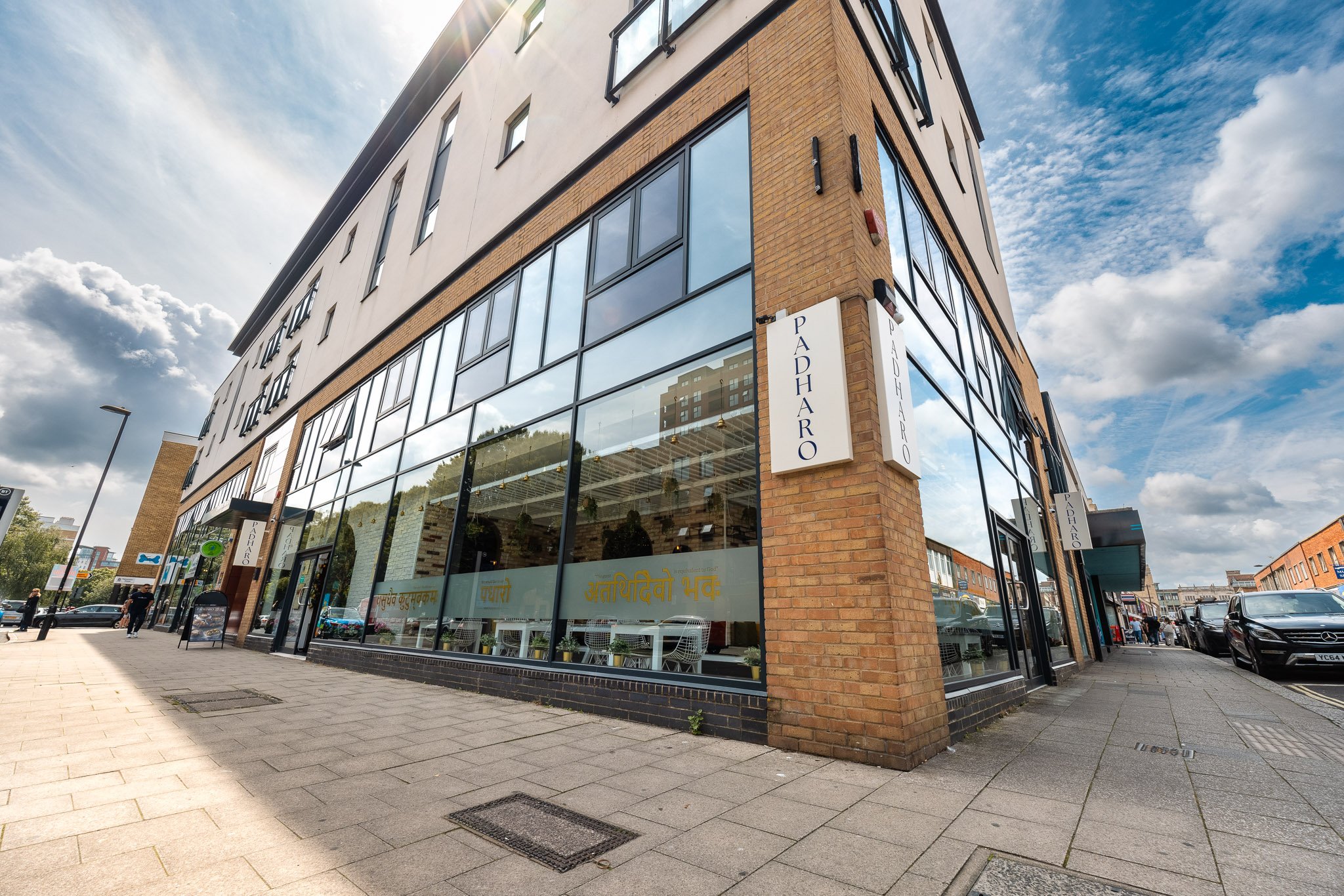 Modern event venue at Padharo Indian Restaurant with large glass windows for networking events.