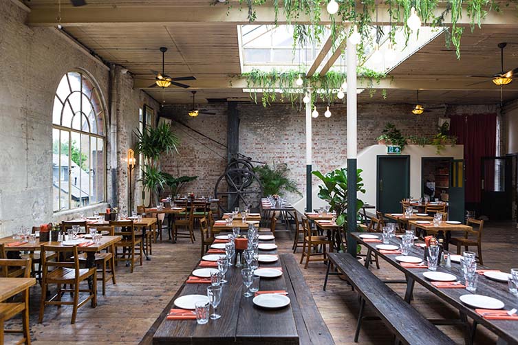 Rustic restaurant event space with wooden tables, ideal for intimate dinners and gatherings.