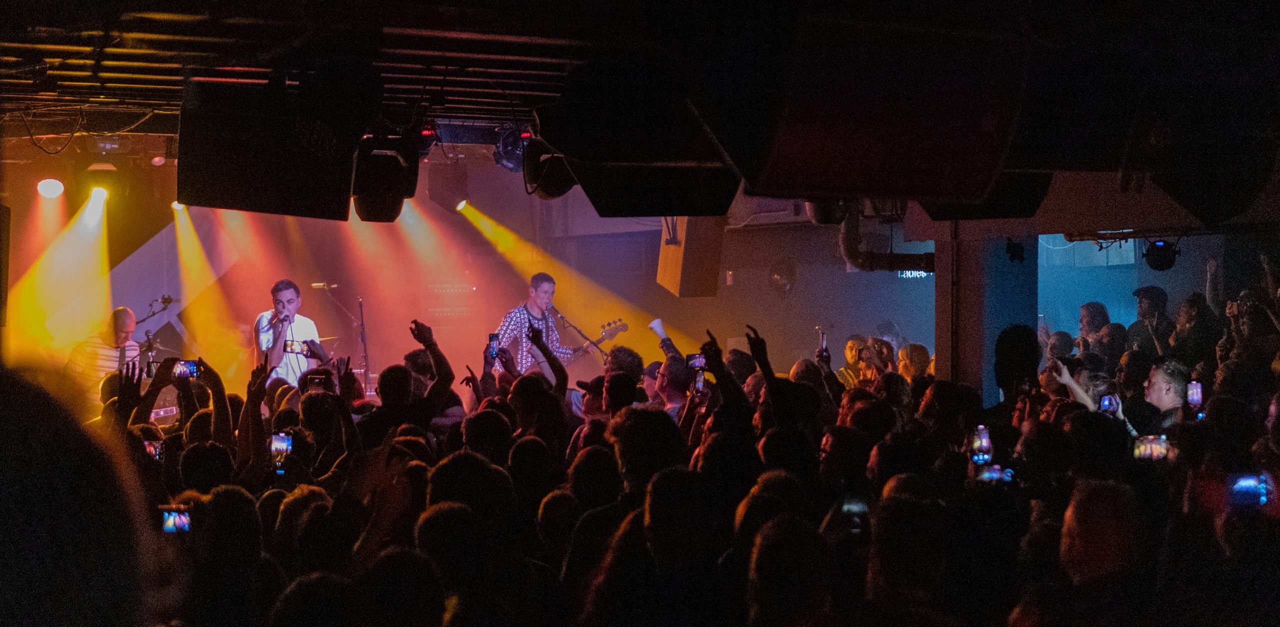 Vibrant live performance in Main Hall, T.E Dingwall Building, engaging audience atmosphere.